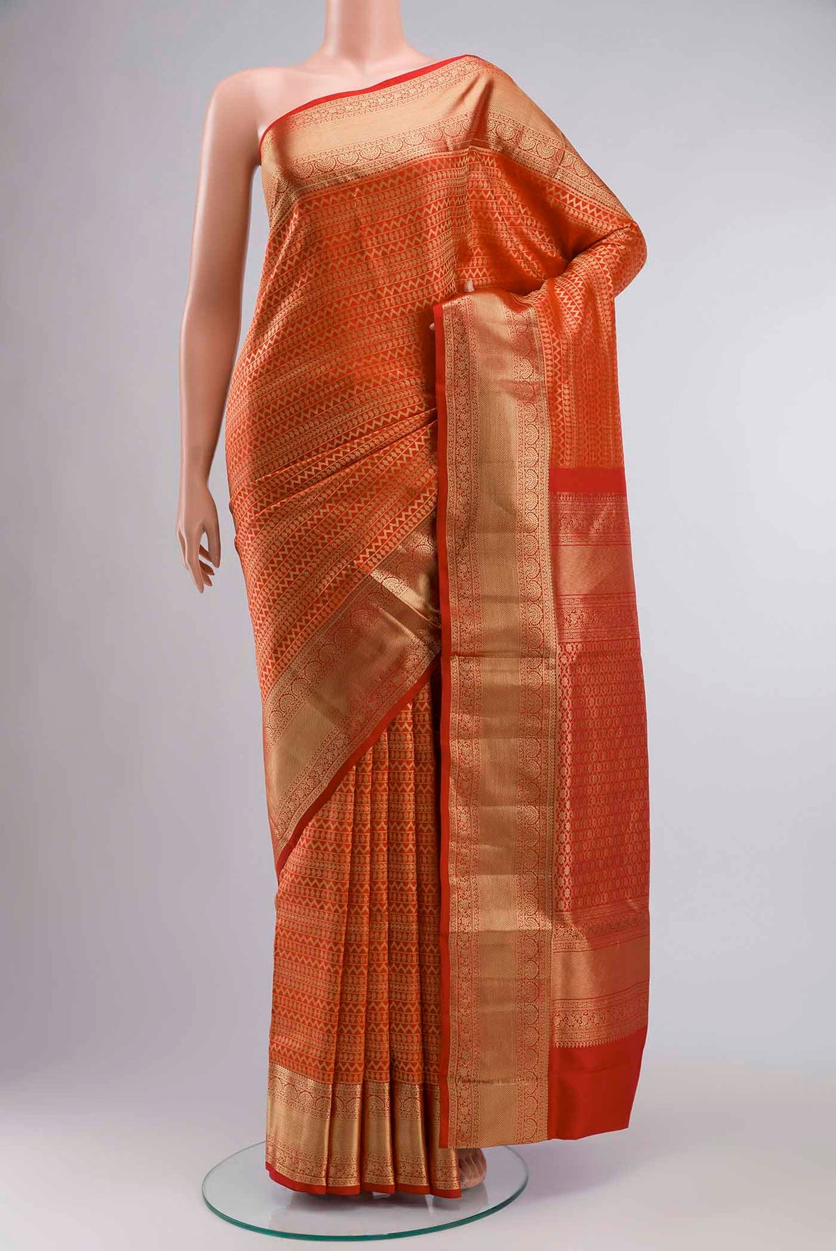 Red Soft Silk Saree with Stripes on the body and Zari Border displayed on a mannequin