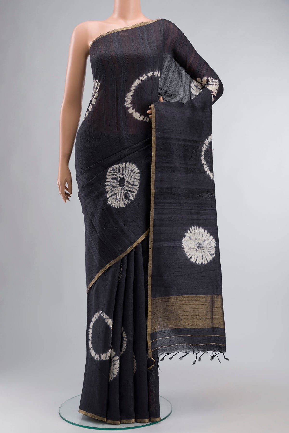 Grey Raw Silk Saree with Printed design on the body and Zari Border displayed on a mannequin