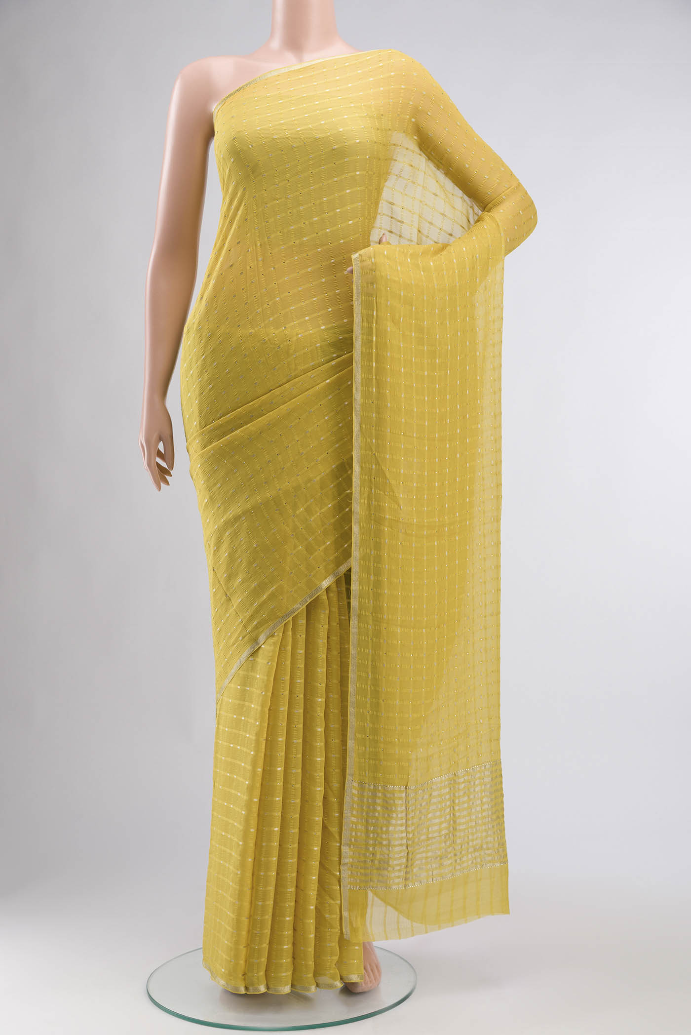 Yellow Mysore Chiffon Saree with Embroidery on the body and Zari Border displayed on a mannequin