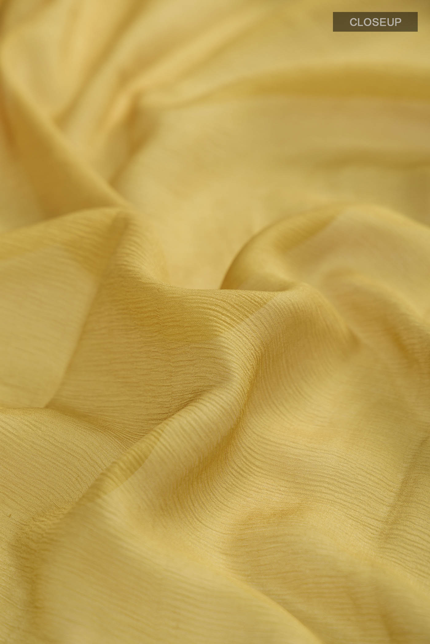 Close up of Brown Mysore Chiffon Saree with Plain Body and Zari Border displaying folds