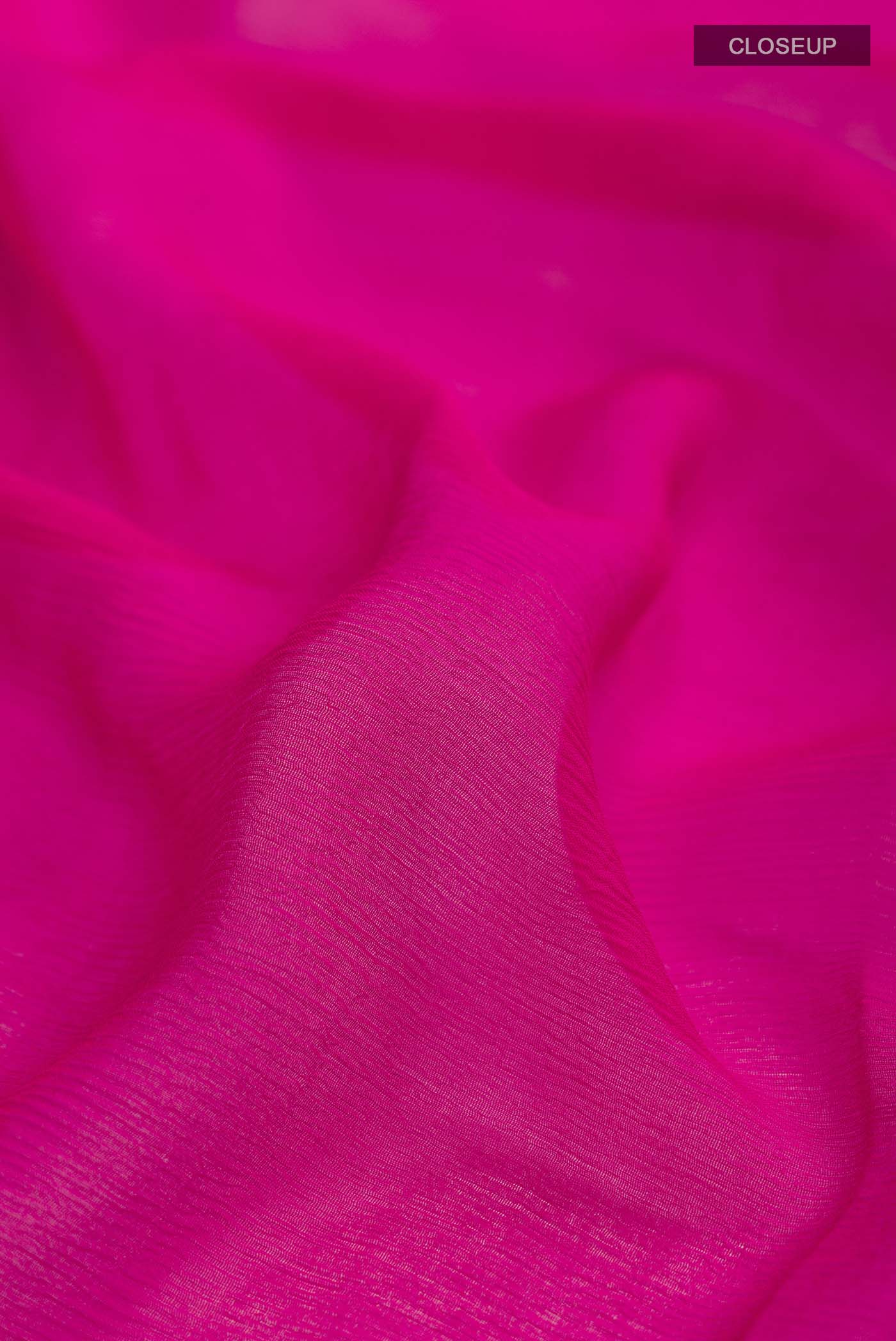 Close up of Pink Mysore Chiffon Saree with Plain Body and Zari Border displaying folds
