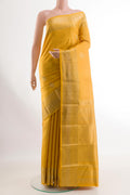 Yellow Kanchipuram Silk Saree with Zari Butta on the body and Zari Border.  displayed on a mannequin