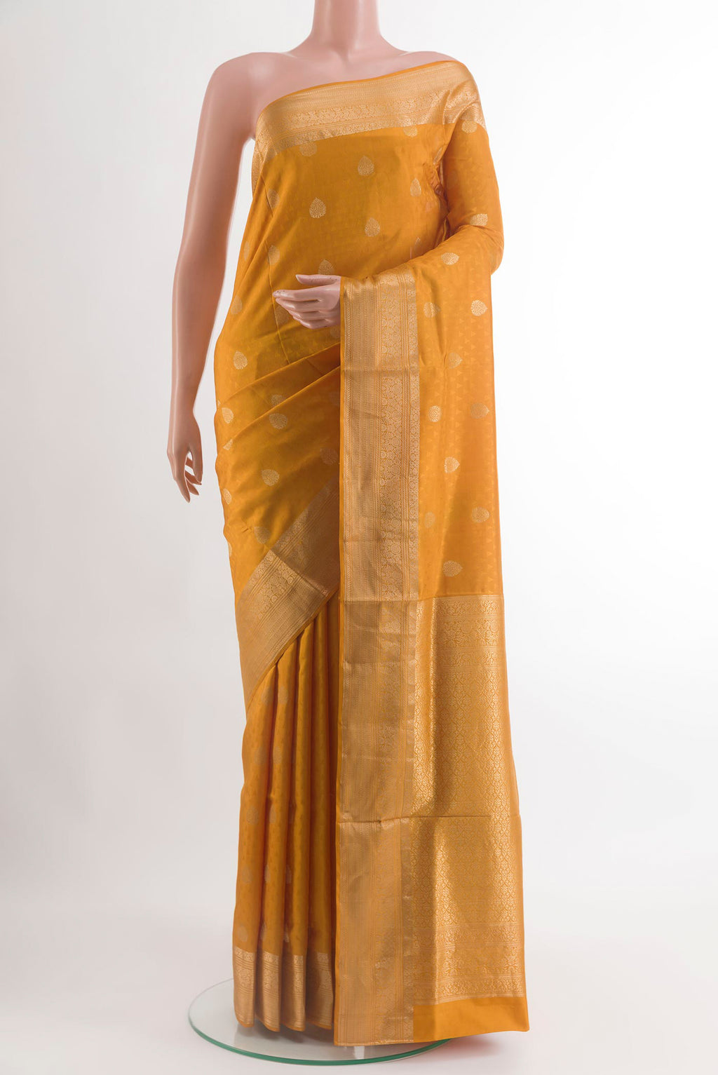 Mustard Soft Silk Saree with Jacquard With Zari Butta on the body and Zari Border.  displayed on a mannequin