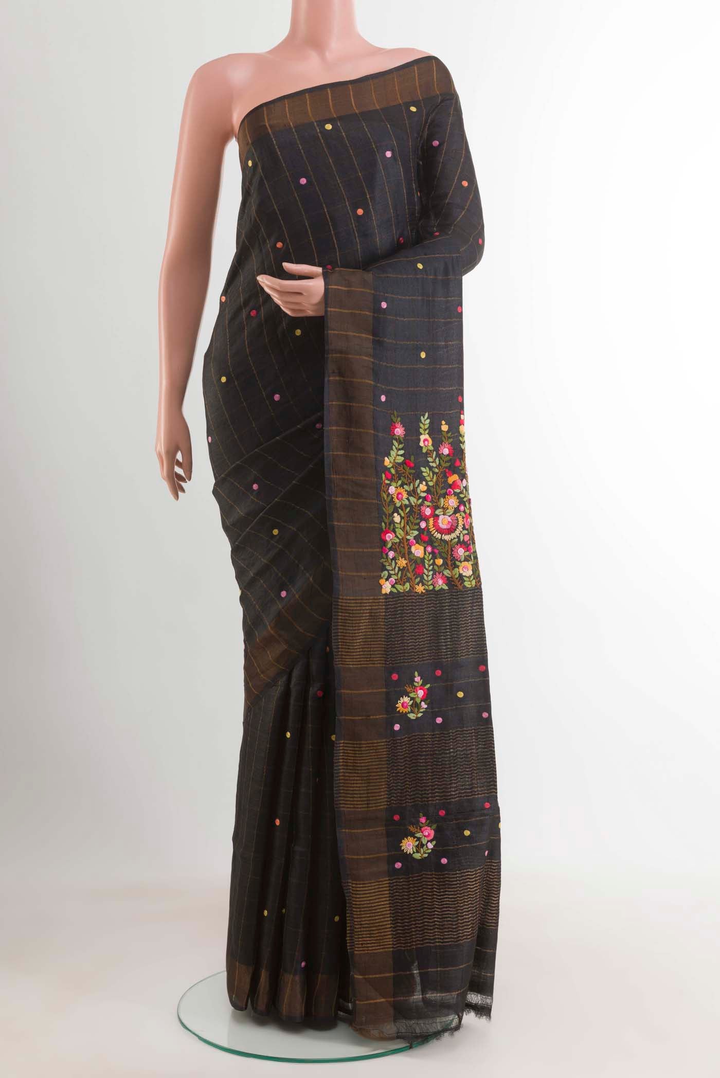 Black Tussar Silk Saree with Embroidery on the body and Zari Border displayed on a mannequin