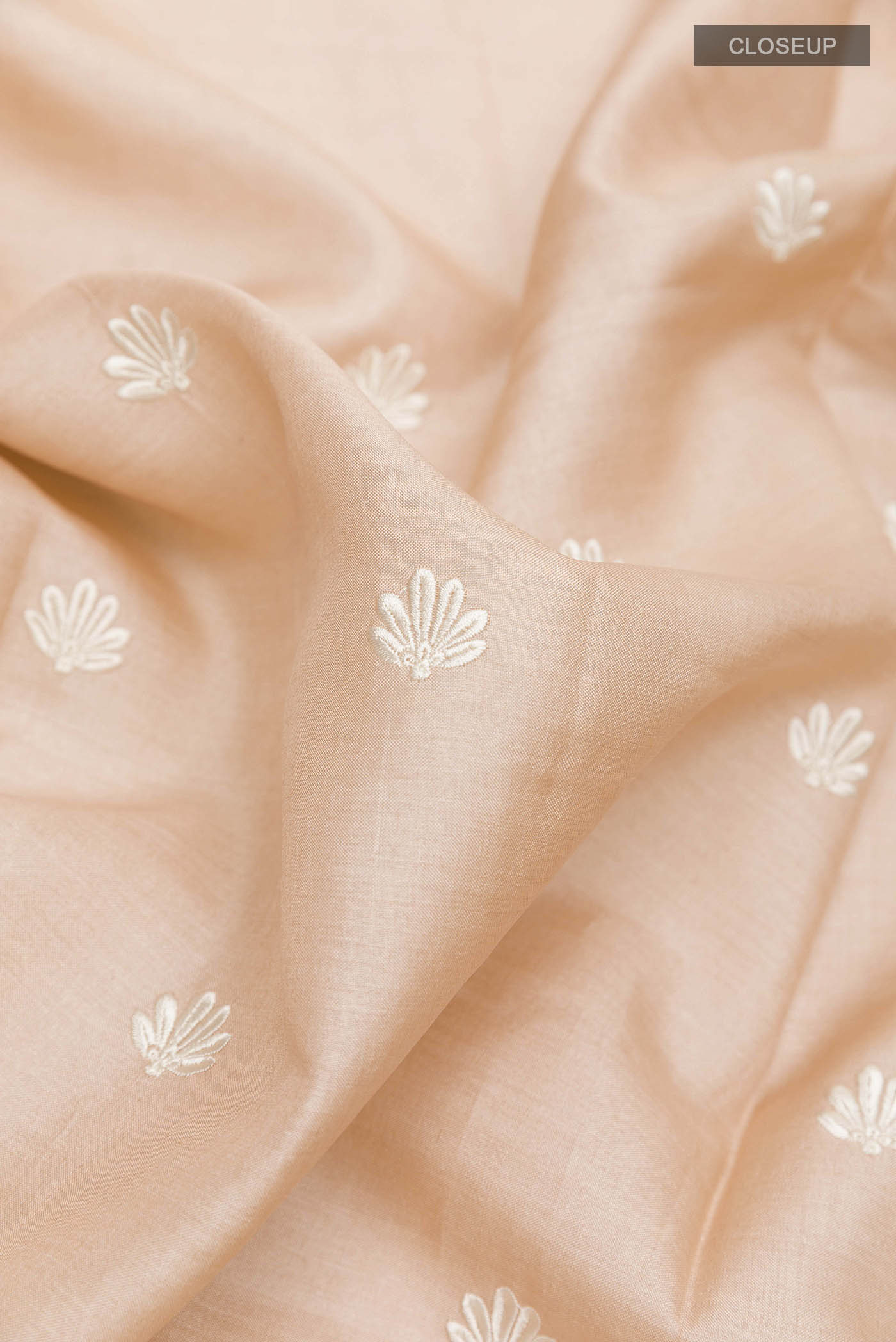 Close up of Imperial Pink Tussar Saree with Thread Butta on the body and Embroidery Border displaying folds