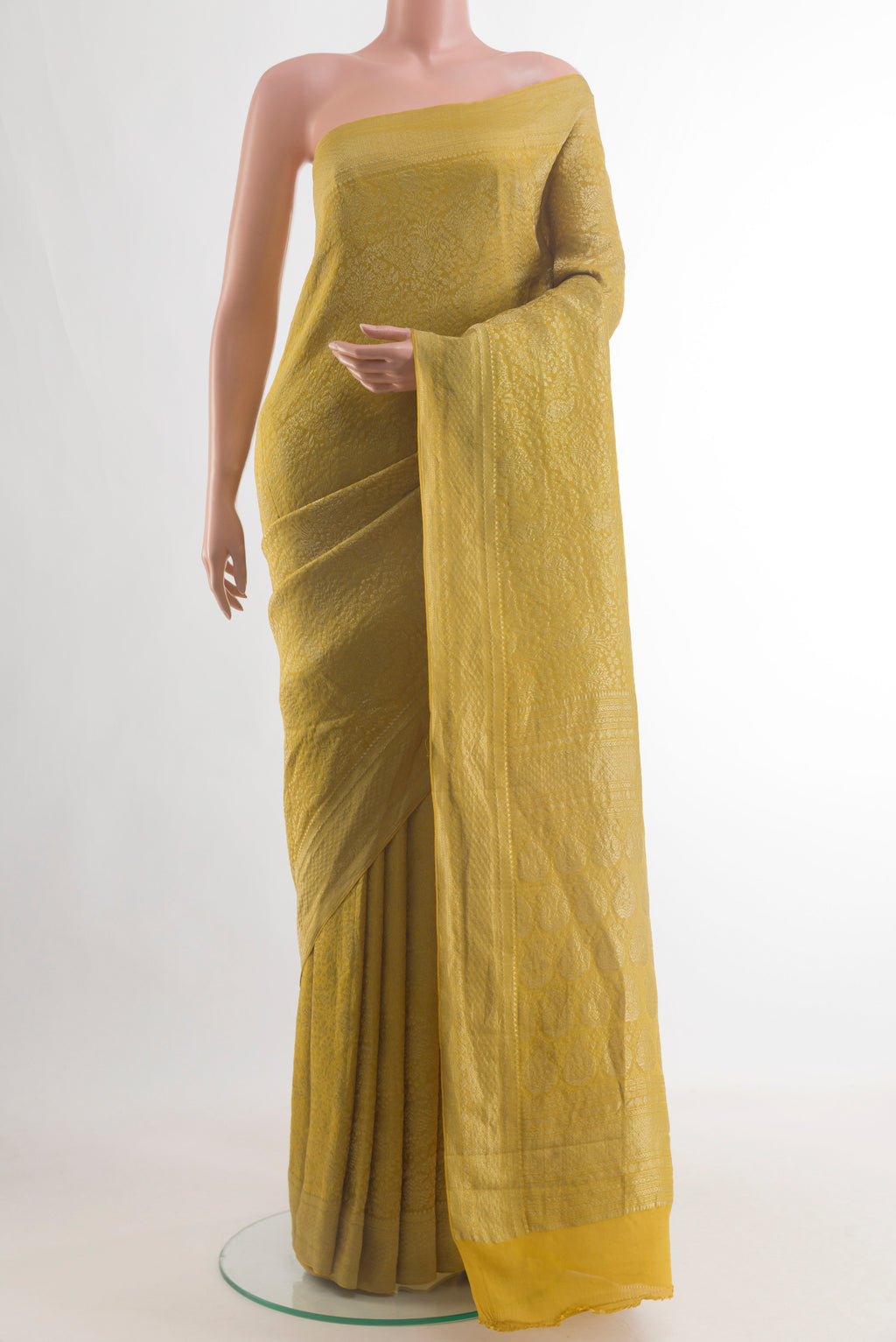 Pure Silk Mustard Mysore Crepe Saree with Zari Brocade on the body and Zari Border.  displayed on a mannequin