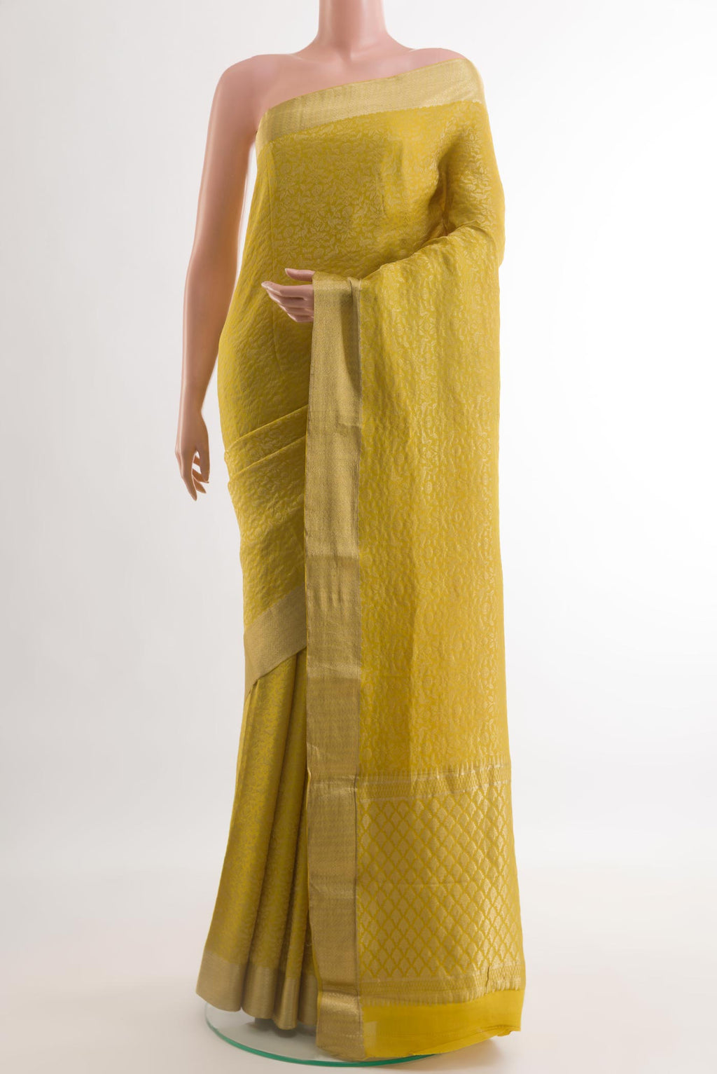 Mustard Mysore Crepe Saree with Zari Brocade on the body and Zari Border.  displayed on a mannequin