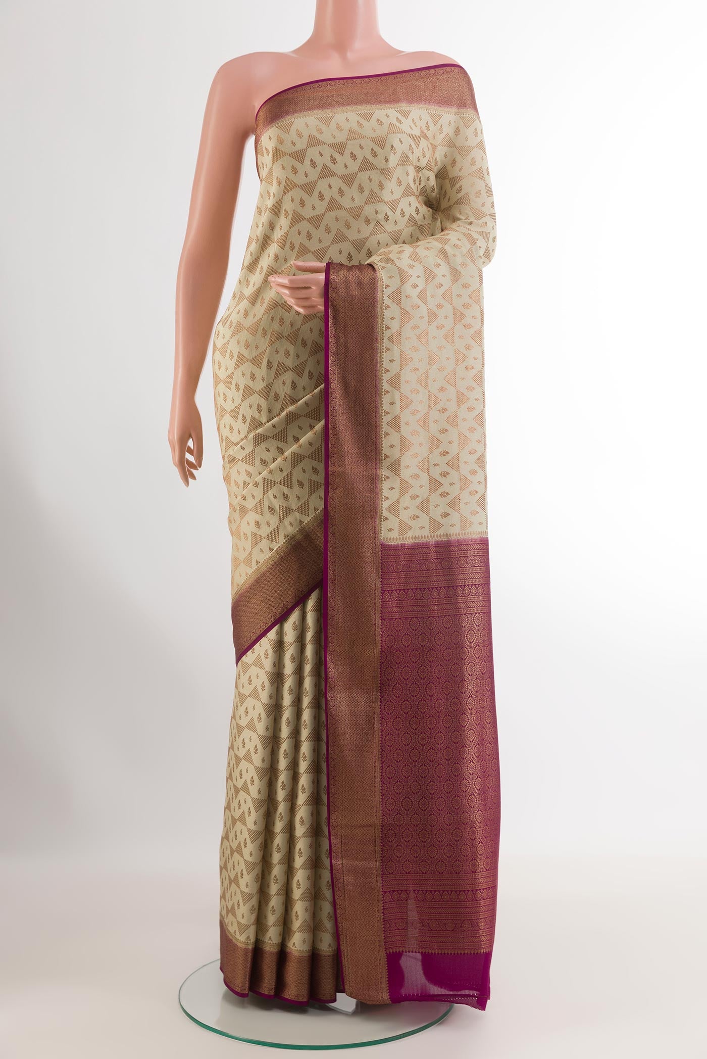 Off White Mysore Crepe Saree with Zari Brocade on the body and Zari Border.  displayed on a mannequin