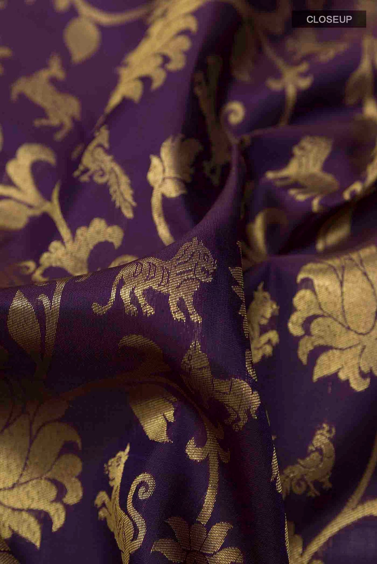 Close up of Pure Silk Pure Zari Purple Kanchipuram Saree with Zari Brocade on the body and Zari Border displaying folds