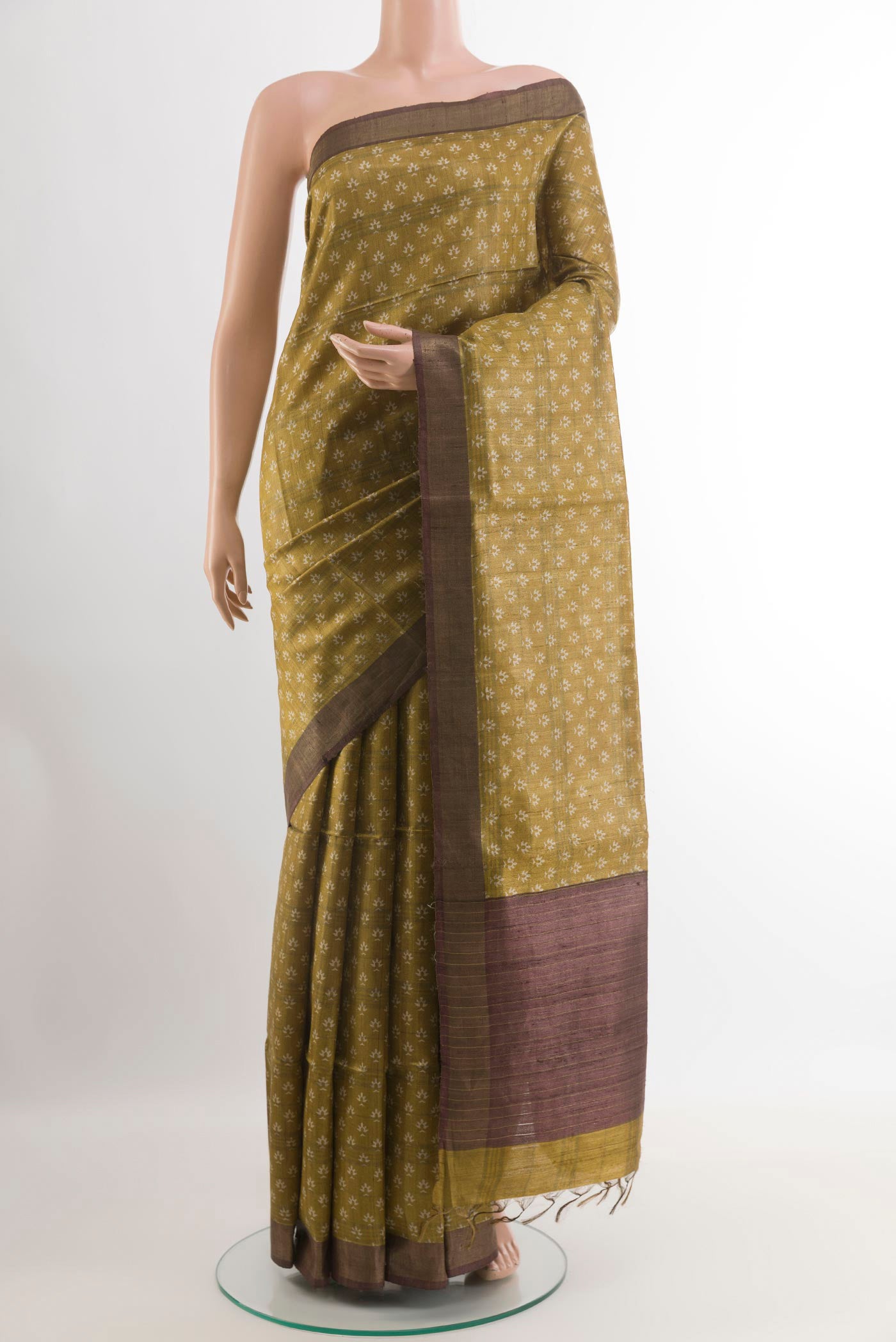 Yellow Tussar Saree with Printed design on the body and Zari Border.  displayed on a mannequin