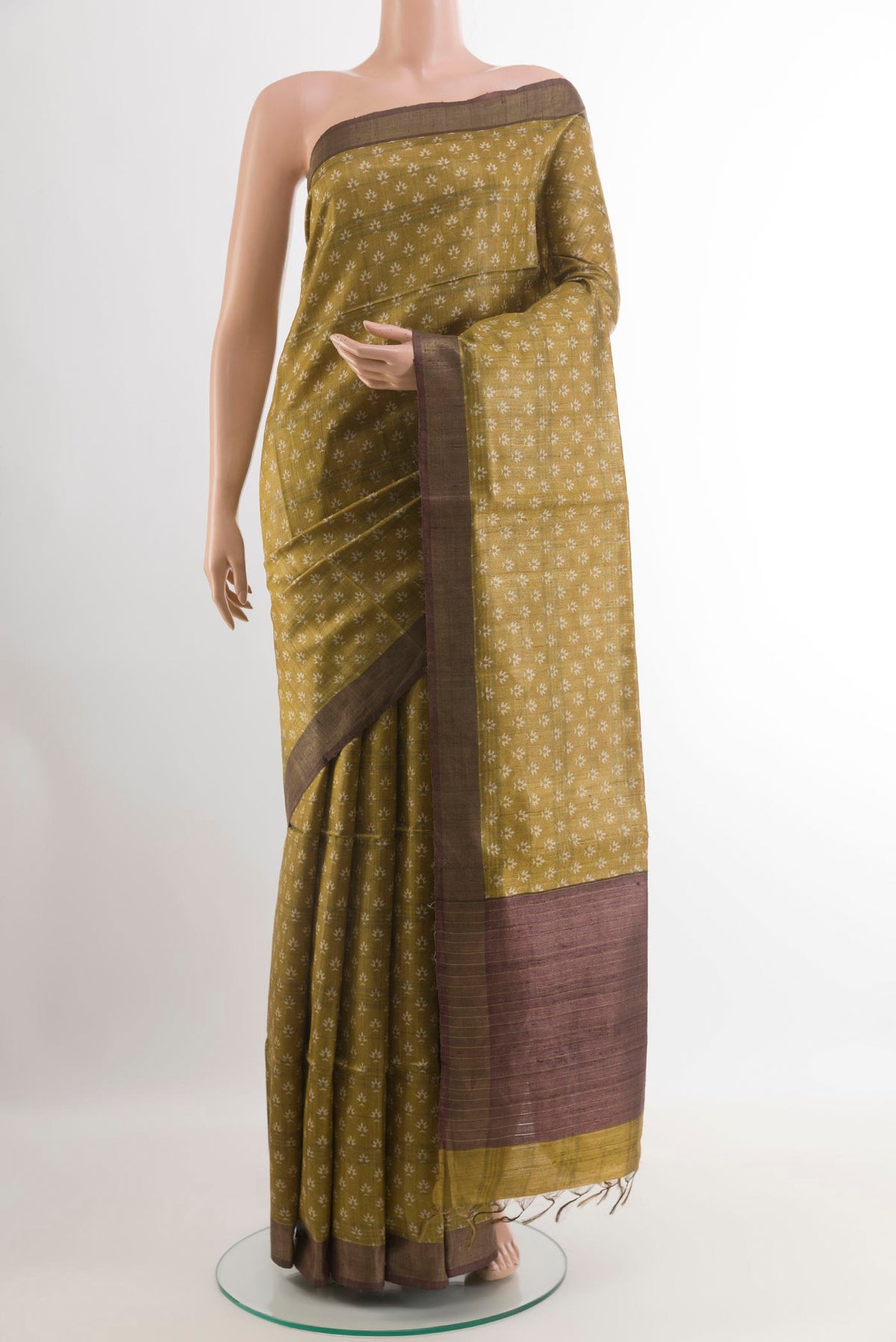 Yellow Tussar Saree with Printed design on the body and Zari Border.  displayed on a mannequin