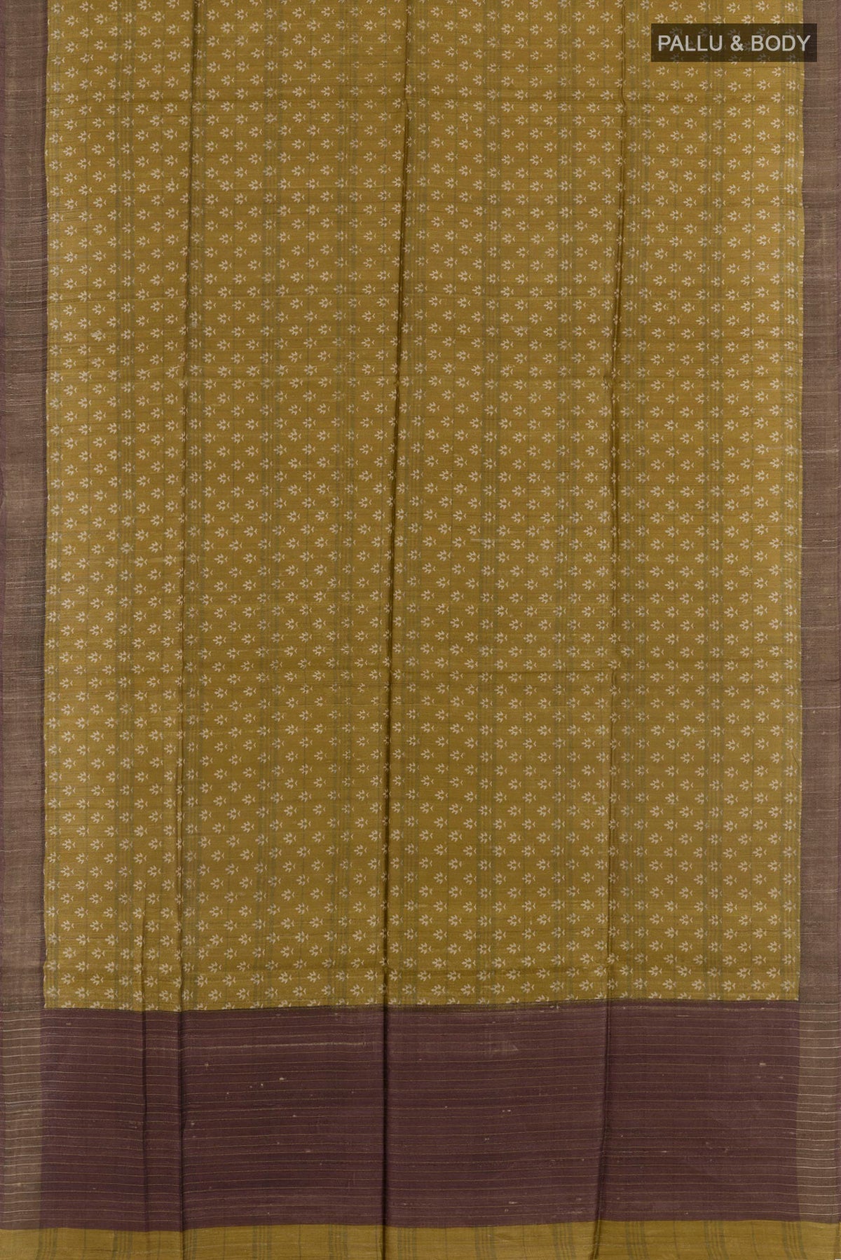 Flat view of Yellow Tussar Saree with Printed design on the body and Zari Border. 