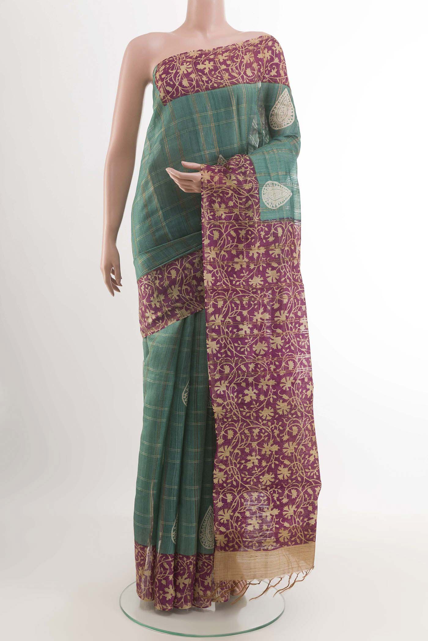 Turquoise Tussar Saree with Checked design on the body and Zari Border displayed on a mannequin