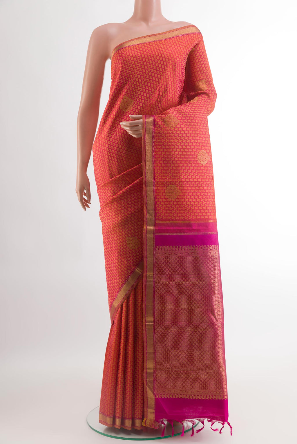 Brick Orange Kanjivaram Silk Saree with Jacquard With Zari Butta on the body and Zari Border.  displayed on a mannequin