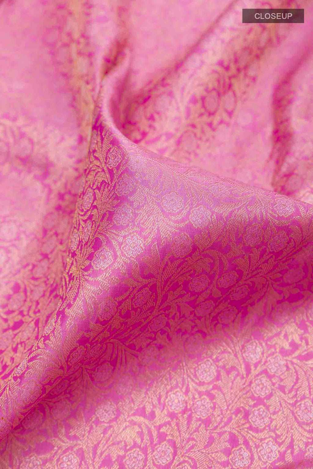 Close up of Pure Silk Pure Zari Pink Kanchipuram Saree with Zari Brocade on the body and Zari Border displaying folds