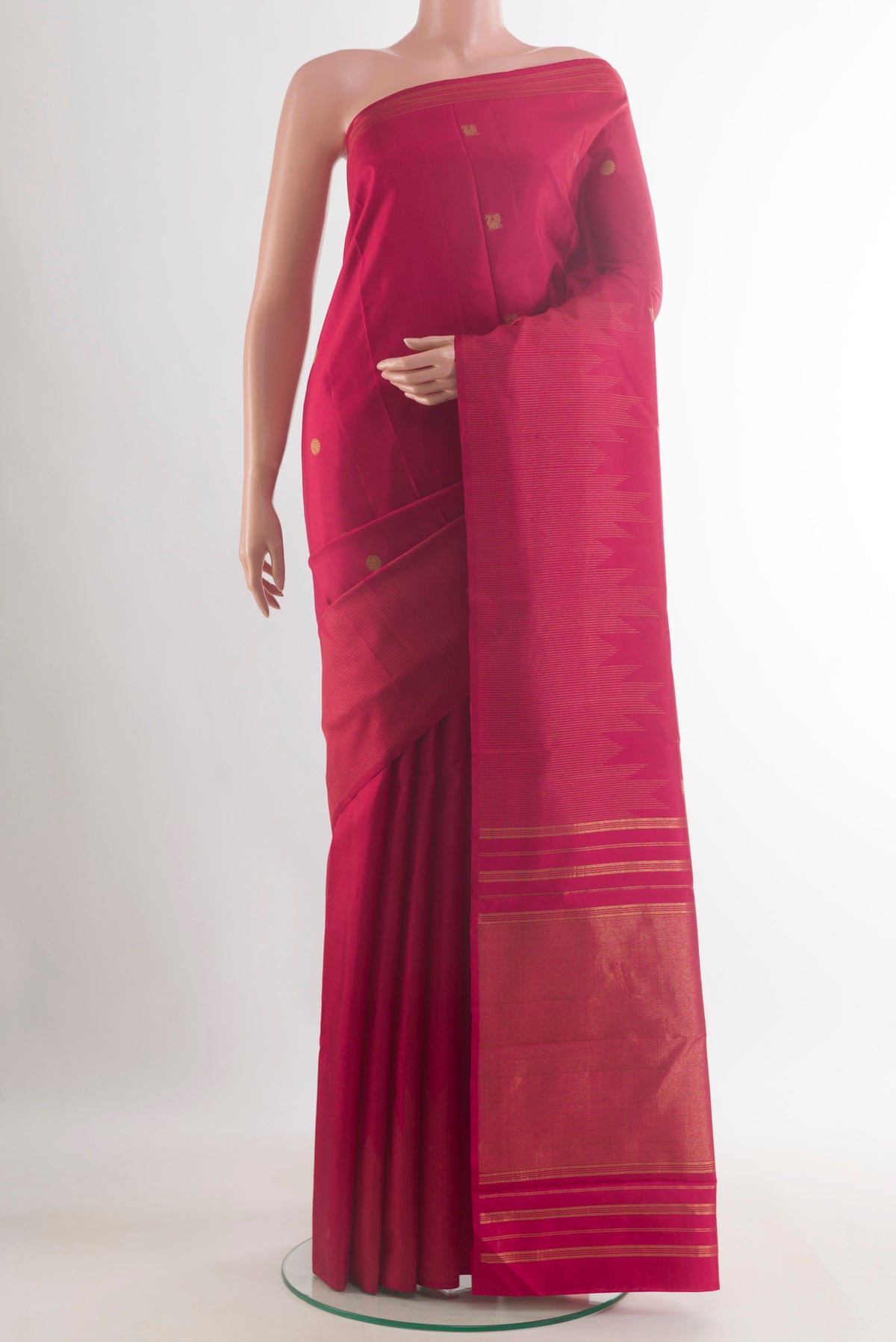 Pure Silk Maroon Kanjivaram Saree with Zari Butta on the body and Zari Border.  displayed on a mannequin