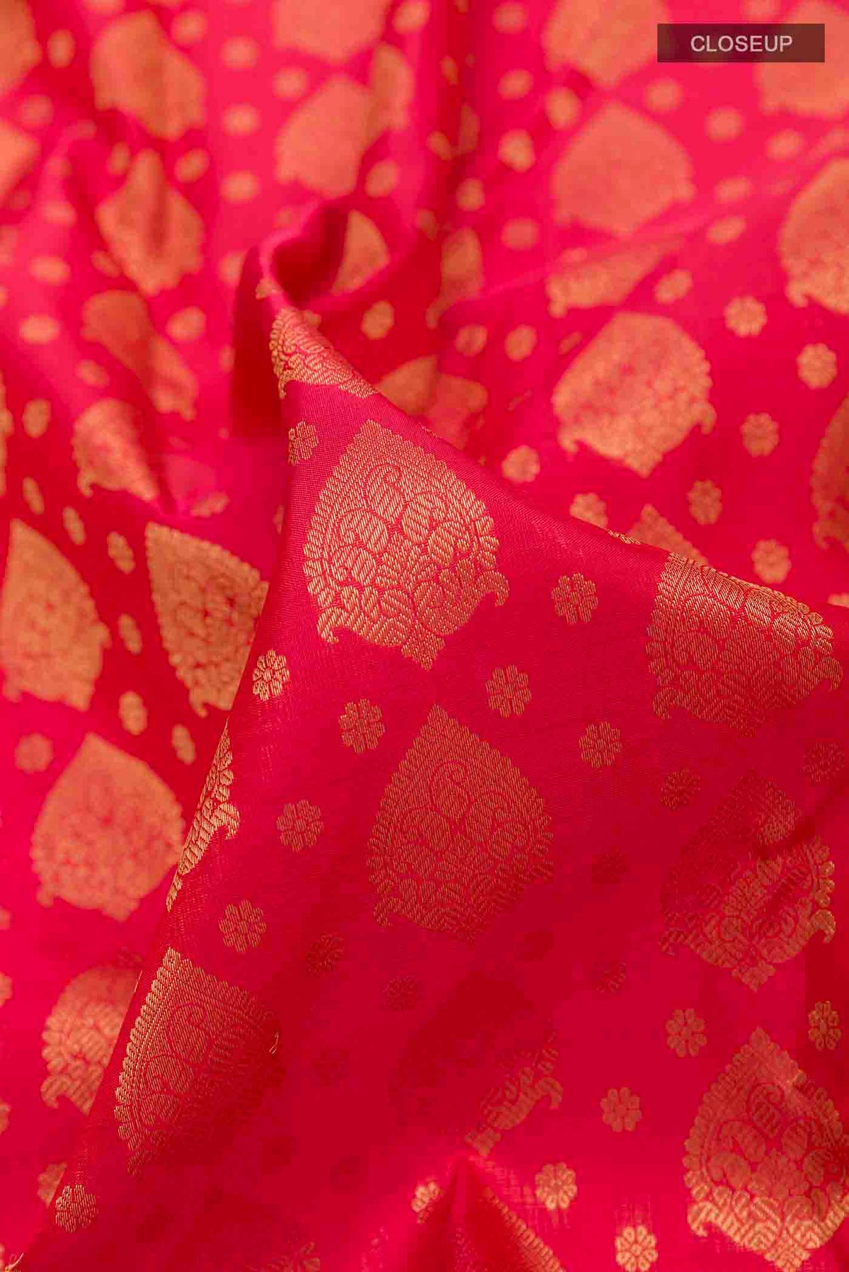 Close up of Pure Silk Pure Zari Red Kanchipuram Saree with Zari Butta on the body and Zari Border displaying folds