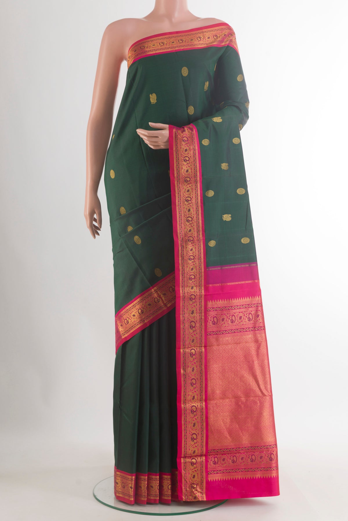 Pure Silk Bottle Green Kanjivaram Saree with Zari Butta on the body and Zari Border.  displayed on a mannequin