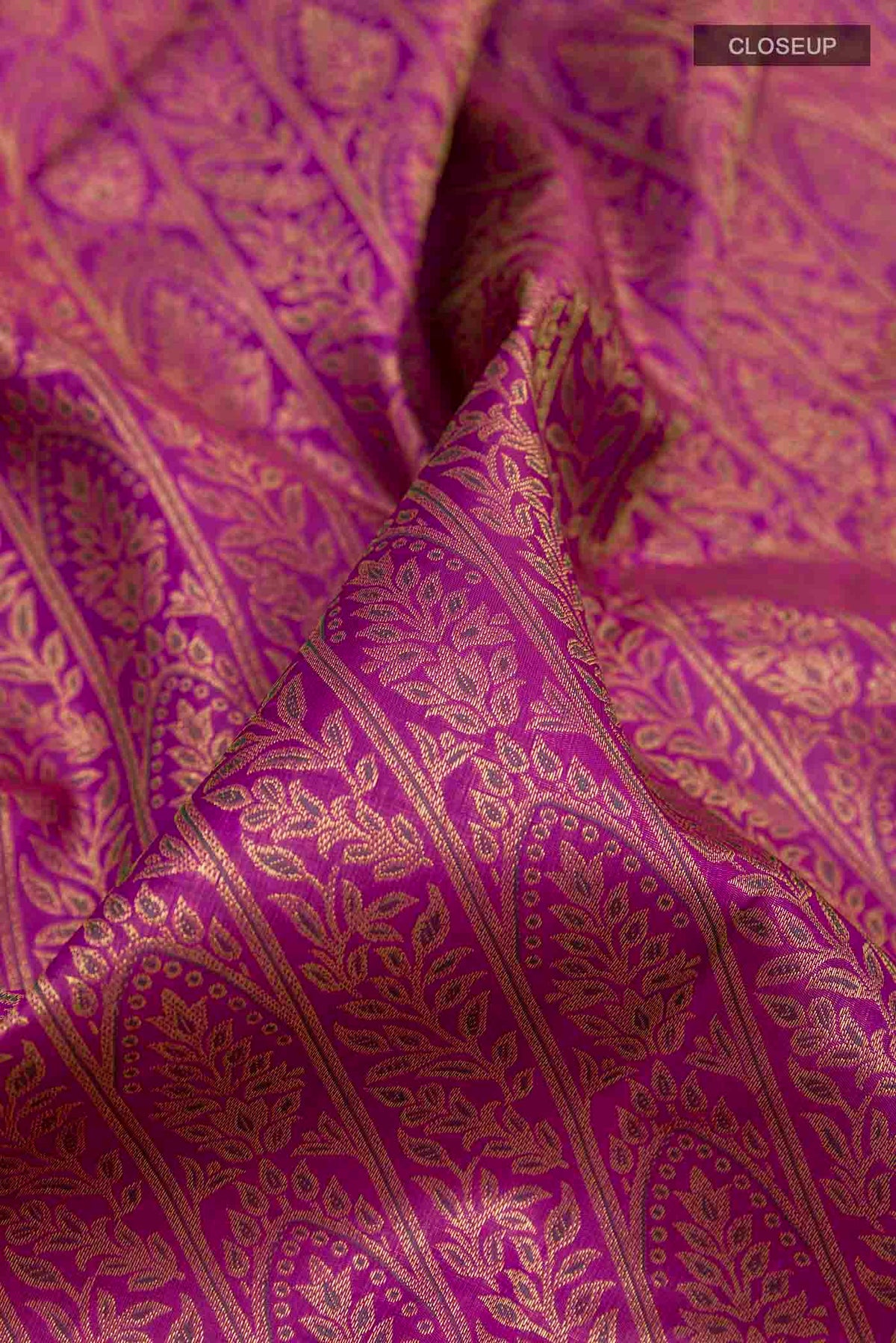 Close up of Pure Silk Pure Zari Purple Kanchipuram Saree with Zari Brocade on the body and Zari Border displaying folds