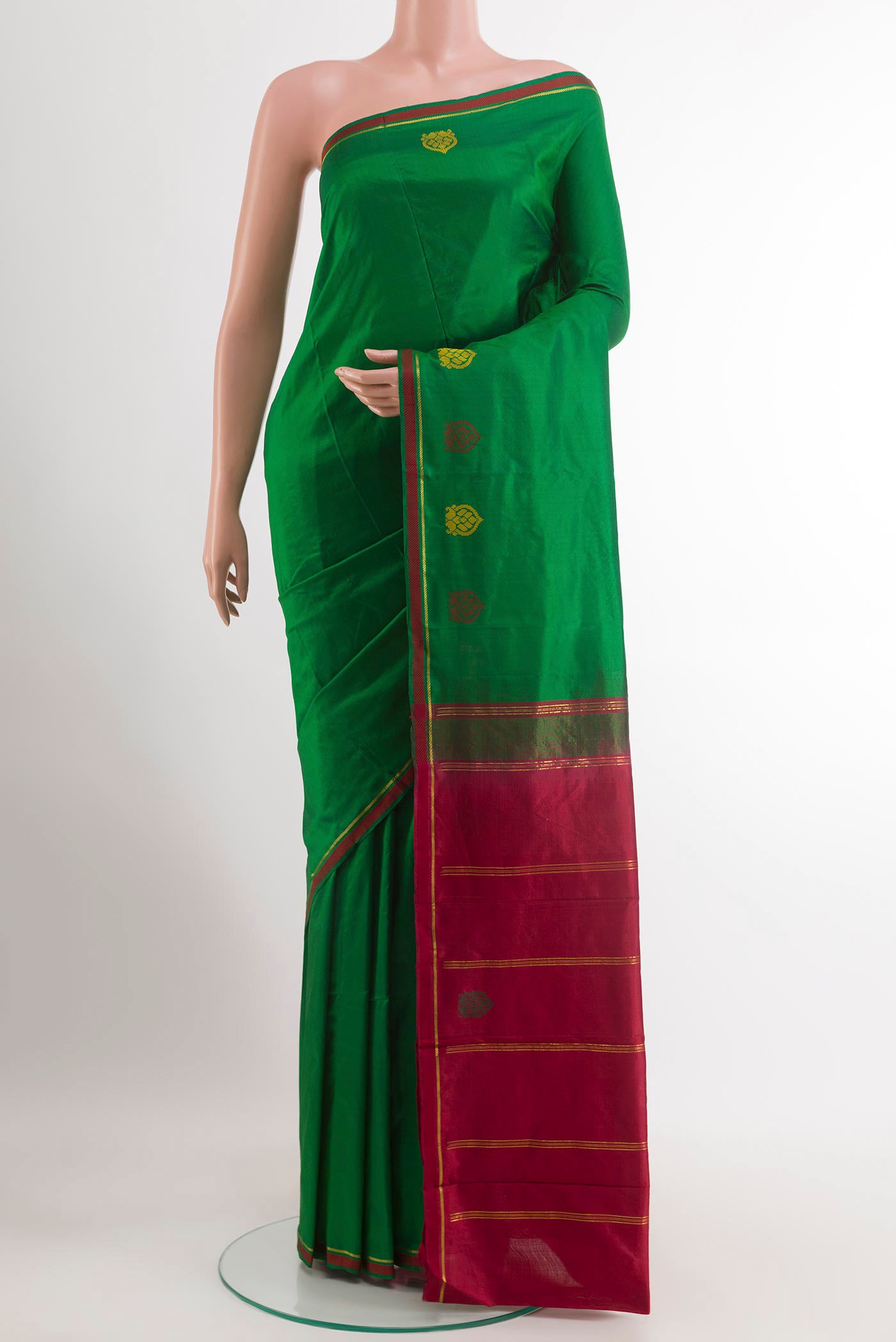 Green Kanchipuram Silk Saree with Plain Body and Zari Border.  displayed on a mannequin