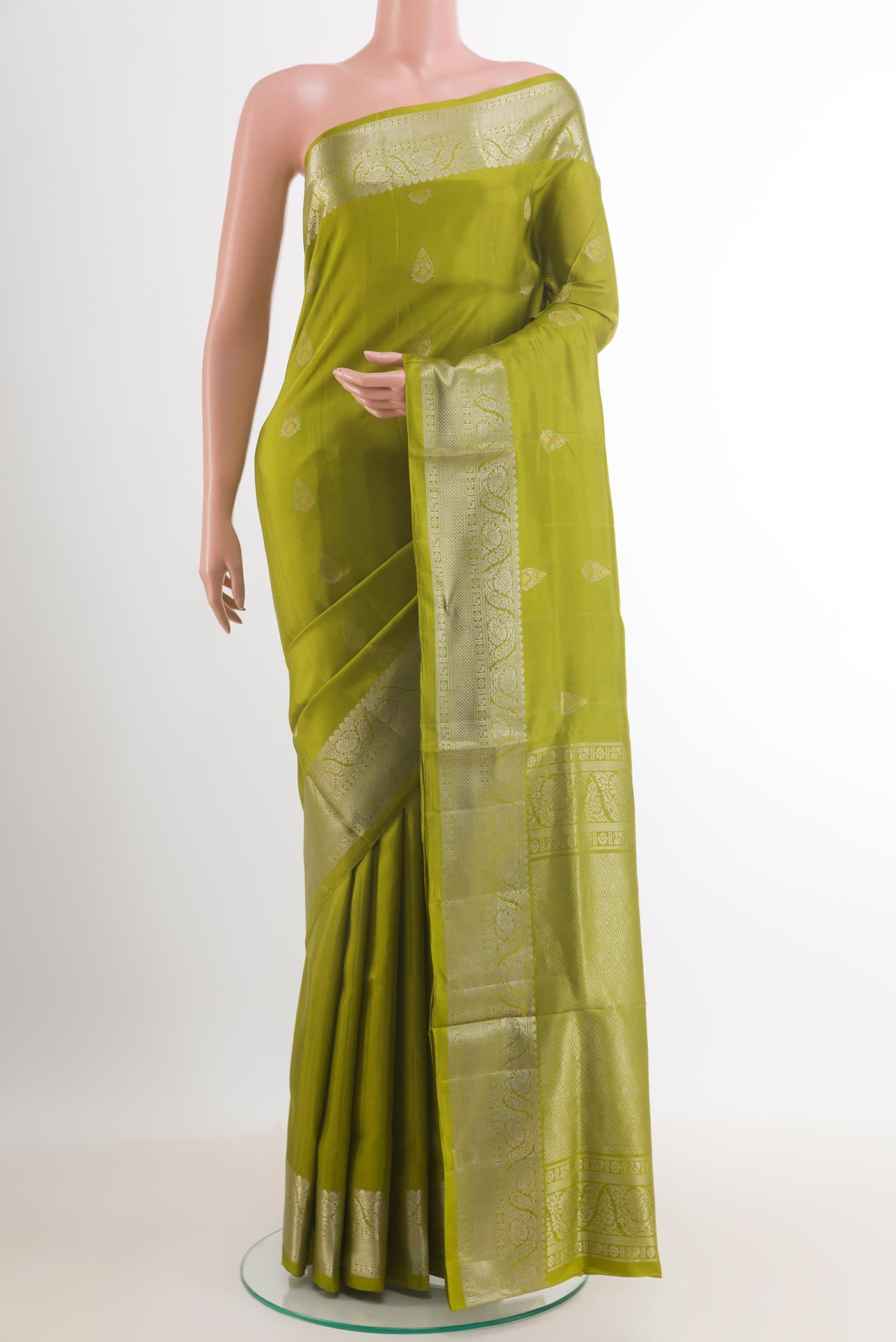 Green Soft Silk Saree with Zari Butta on the body and Zari Border.  displayed on a mannequin