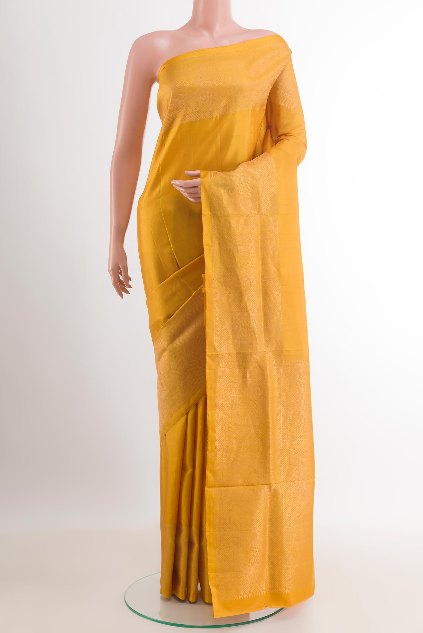 Yellow Soft Silk Saree with Plain Body and Zari Border.  displayed on a mannequin