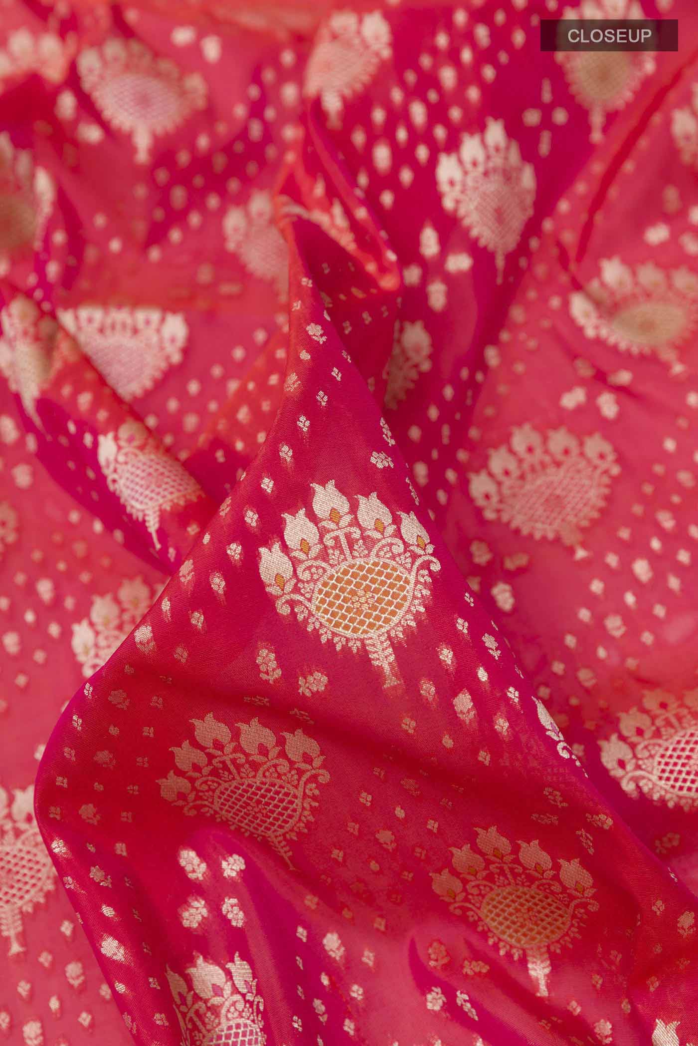 Close up of Red Banarasi Silk Saree with Zari Butta on the body and Zari Border displaying folds