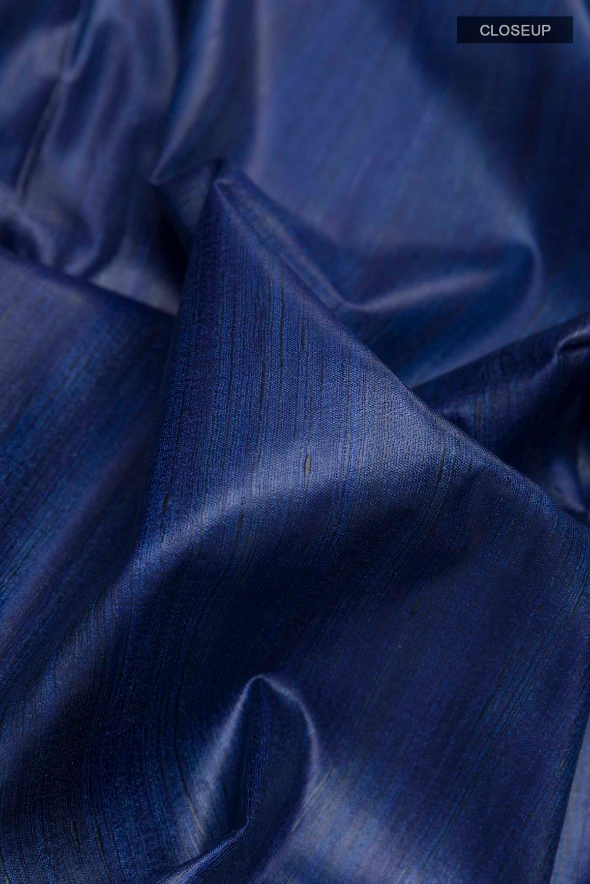 Close up of Blue Tussar Saree with Printed design on the body and Printed Border displaying folds
