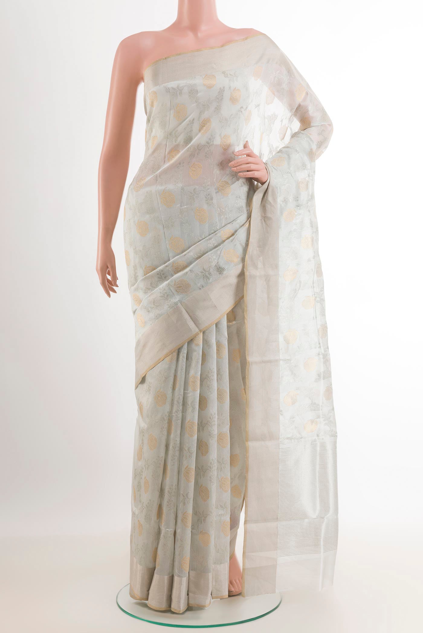 Off White Chanderi Silk Saree with Zari Brocade on the body and Zari Border.  displayed on a mannequin