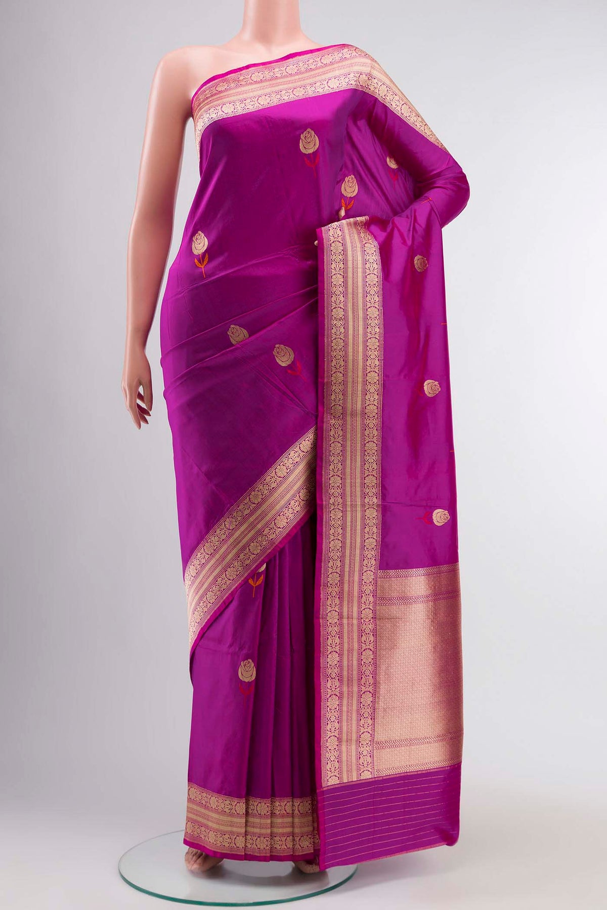 Magenta Banarasi Katan Silk Saree with Zari Butta on the body and Zari Border displayed on a mannequin