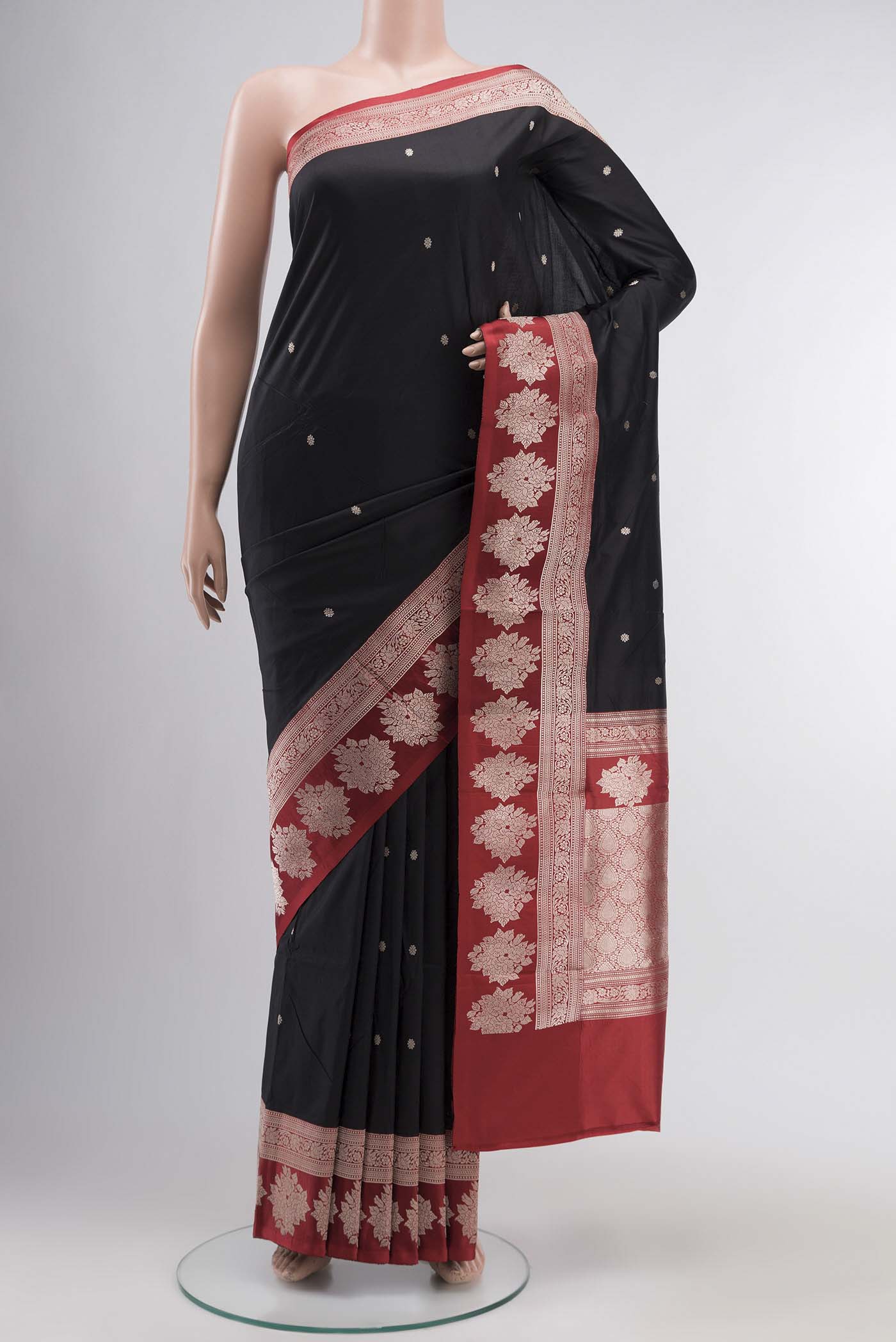 Black Banarasi Katan Silk Saree with Zari Butta on the body and Zari Border displayed on a mannequin