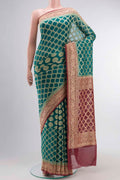 Green Banarasi Georgette Saree with Zari Butta on the body and Zari Border displayed on a mannequin