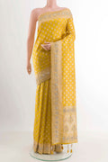 Yellow Banarasi Silk Saree with Zari Butta on the body and Sequin Border displayed on a mannequin