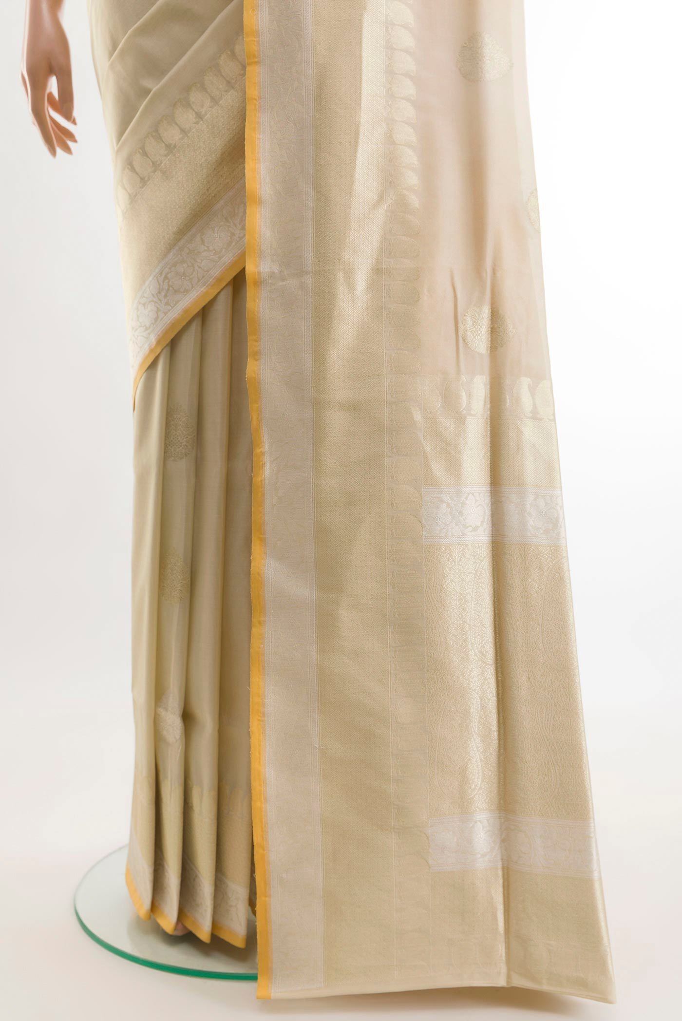 Pleats and pallu of Cream Banarasi Silk Saree with Zari Butta on the body and Zari Border. 