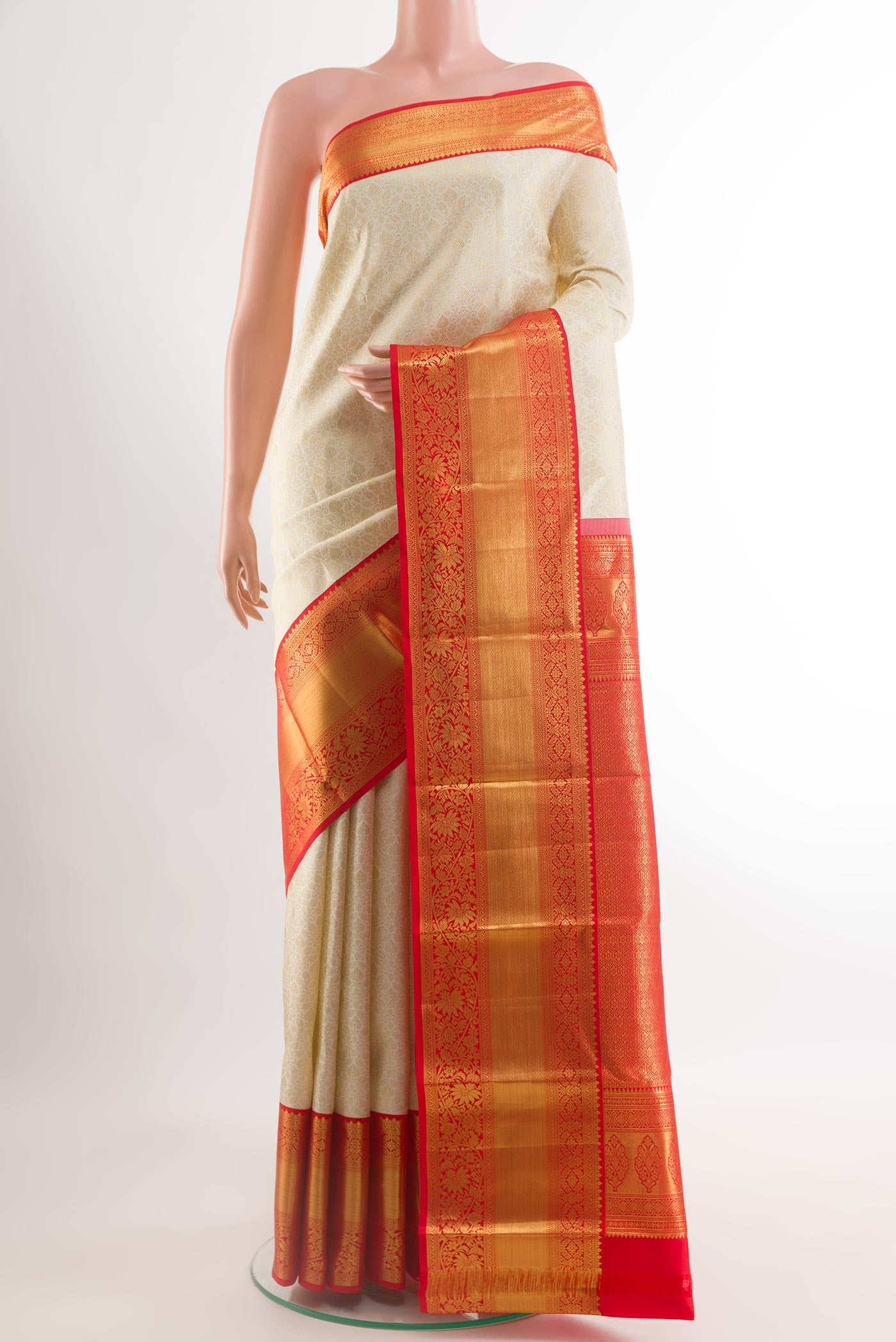 Off White Kanchipuram Silk Saree with Zari Brocade on the body and Zari Border.  displayed on a mannequin
