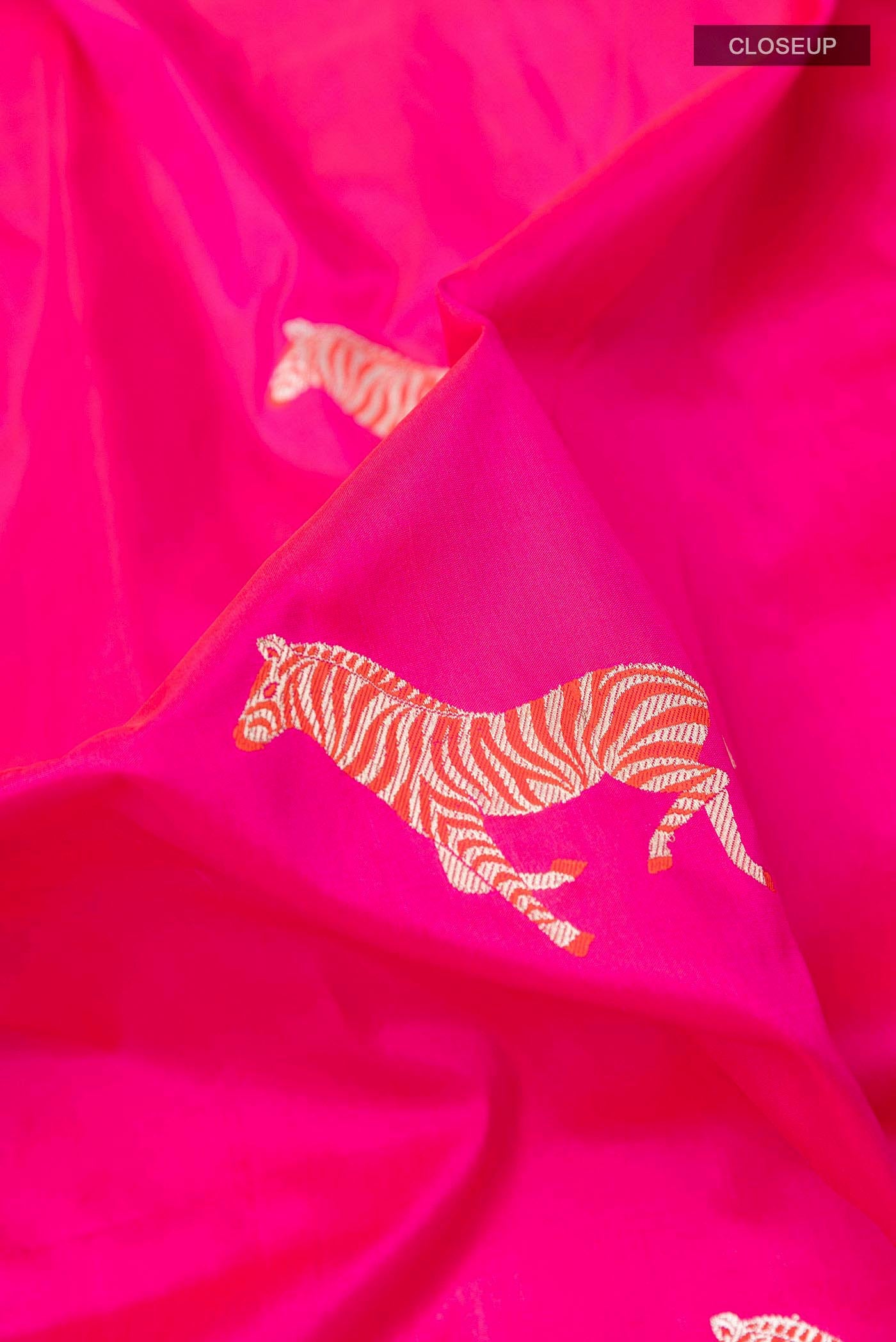 Close up of Pink Banarasi Silk Saree with Zari Butta on the body and Zari Border displaying folds