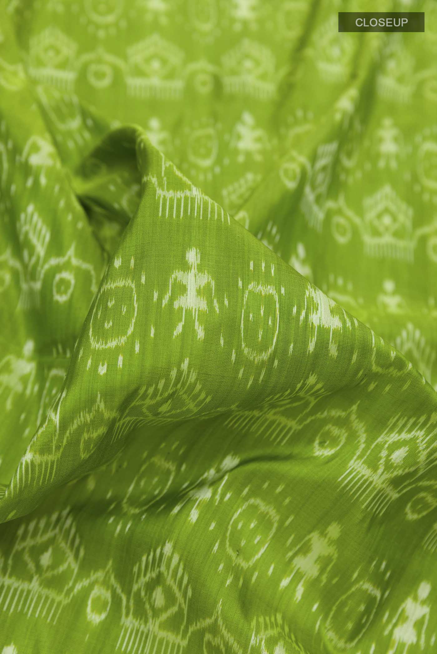 Close up of Green Orissa Silk Saree with Pure Ikat on the body and Thread Border displaying folds
