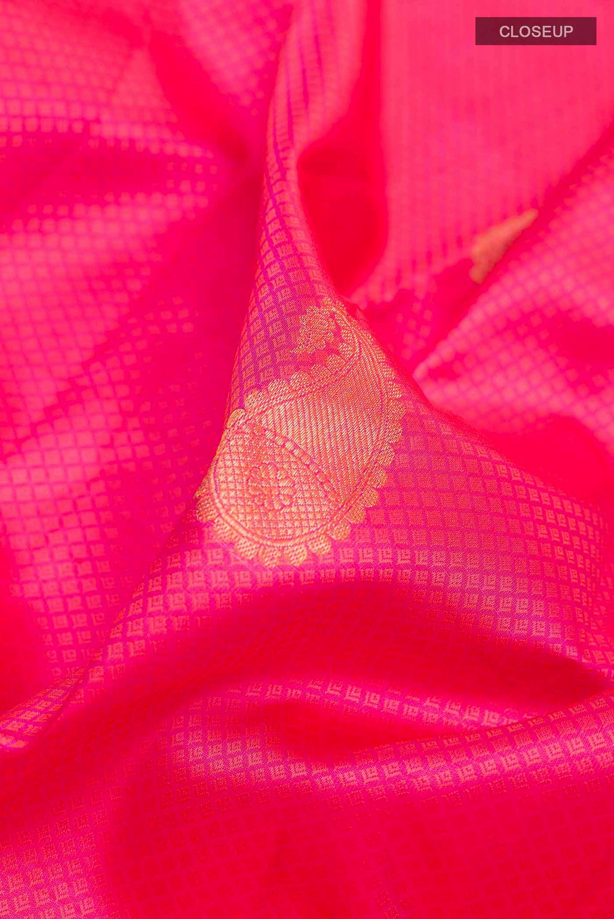 Close up of Pink Kanchipuram Silk Saree with Jacquard With Zari Butta on the body and Zari Border displaying folds