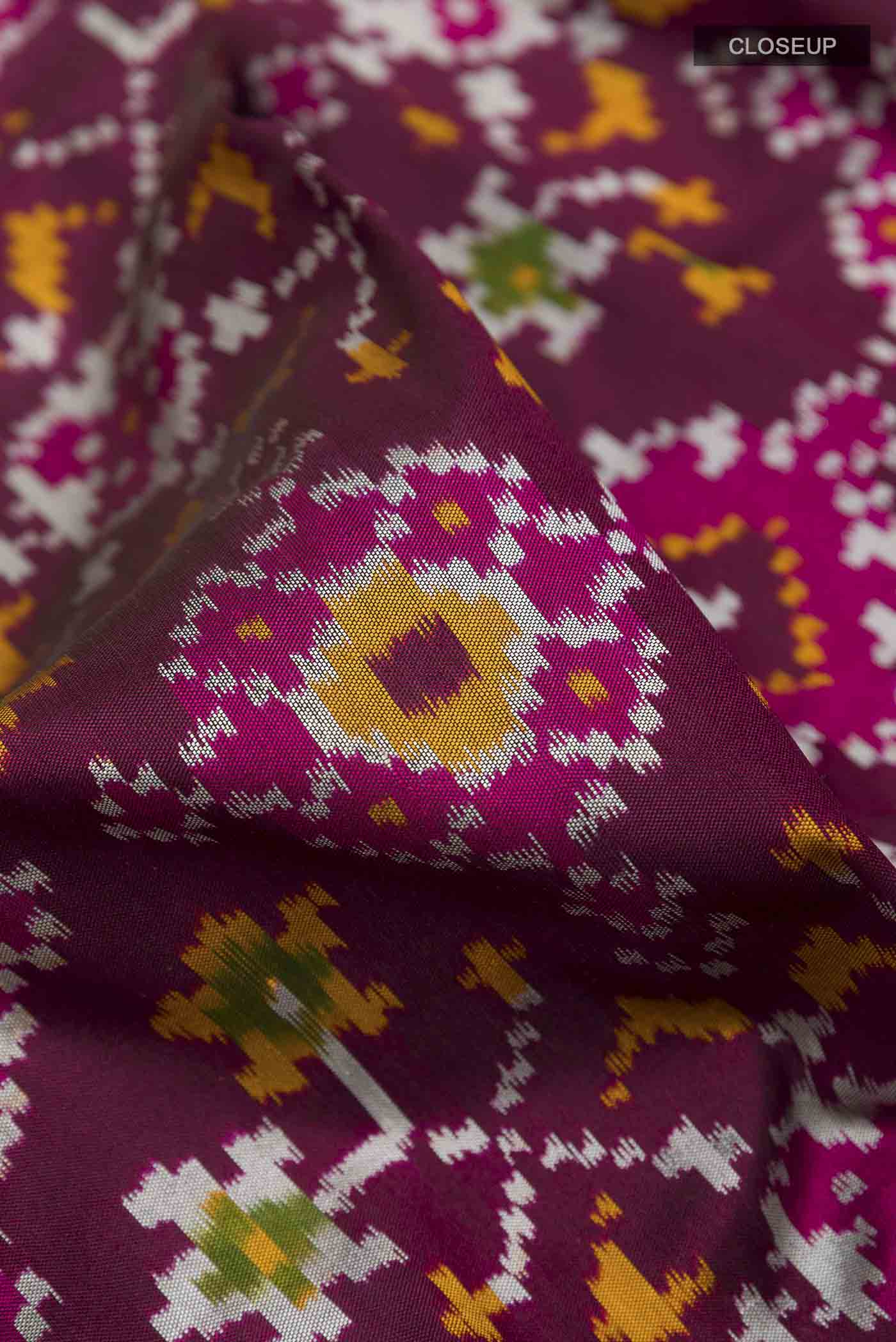 Close up of Purple Dual Tone Pochampally Silk Saree with Pure Ikat on the body and Zari Border displaying folds