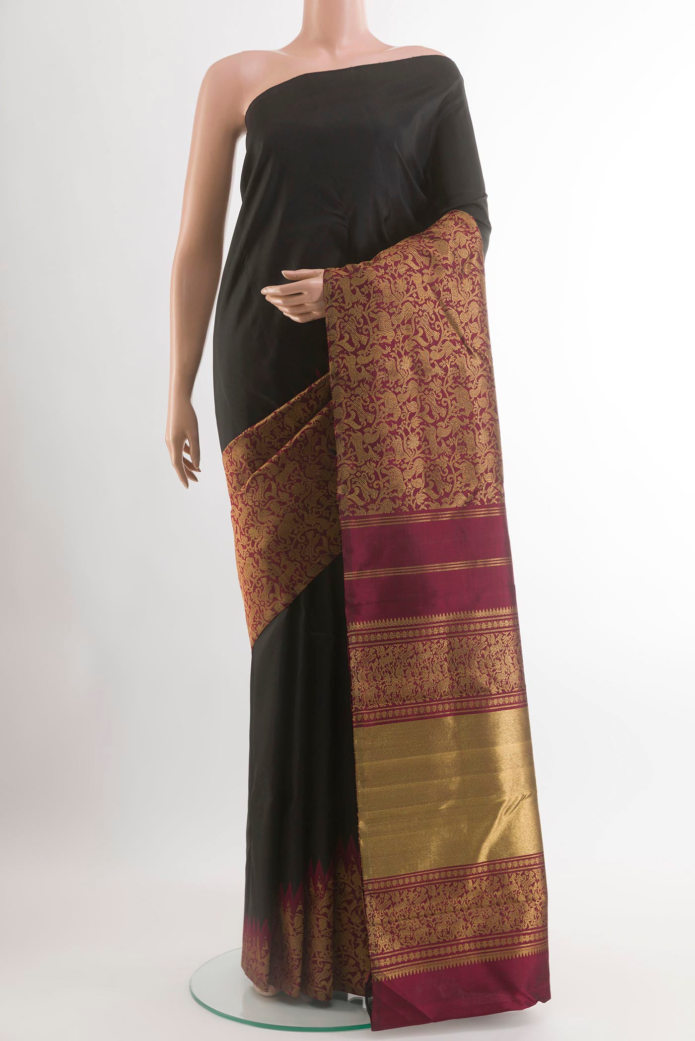 Black Kanchipuram Silk Saree with Plain Body and Zari Border.  displayed on a mannequin