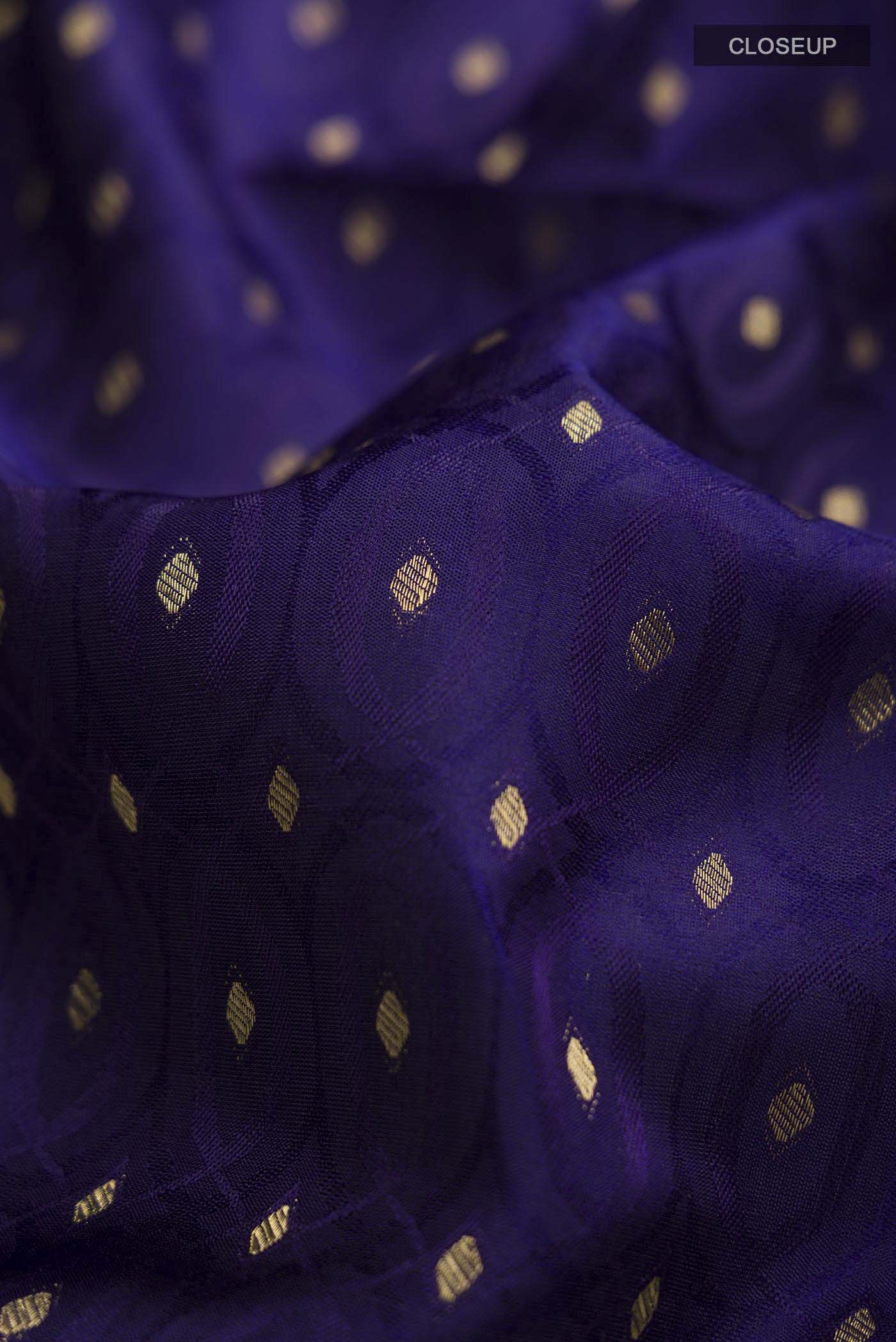 Close up of Navy Blue Soft Silk Saree with Zari Butta on the body and Zari Border displaying folds
