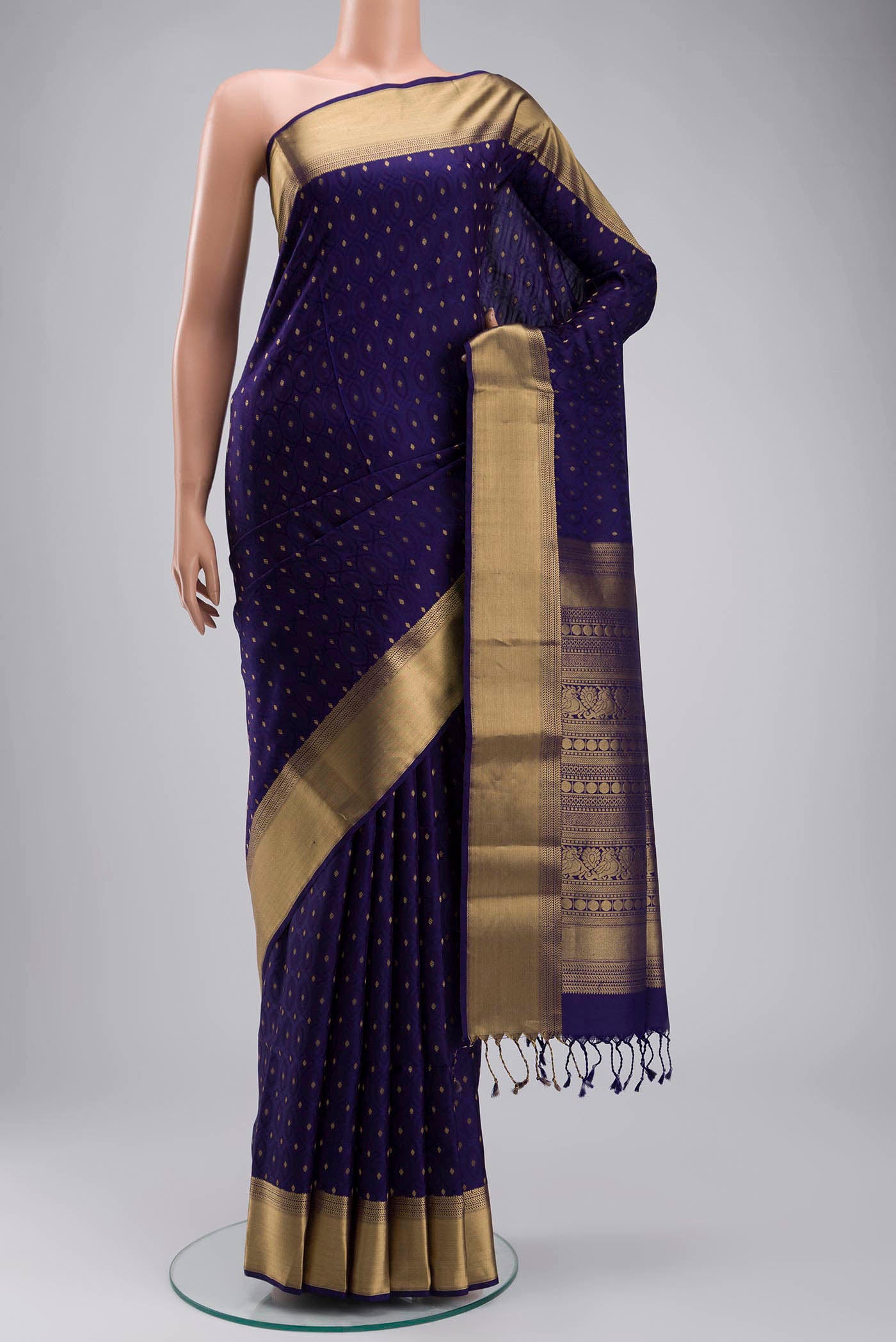 Navy Blue Soft Silk Saree with Zari Butta on the body and Zari Border displayed on a mannequin
