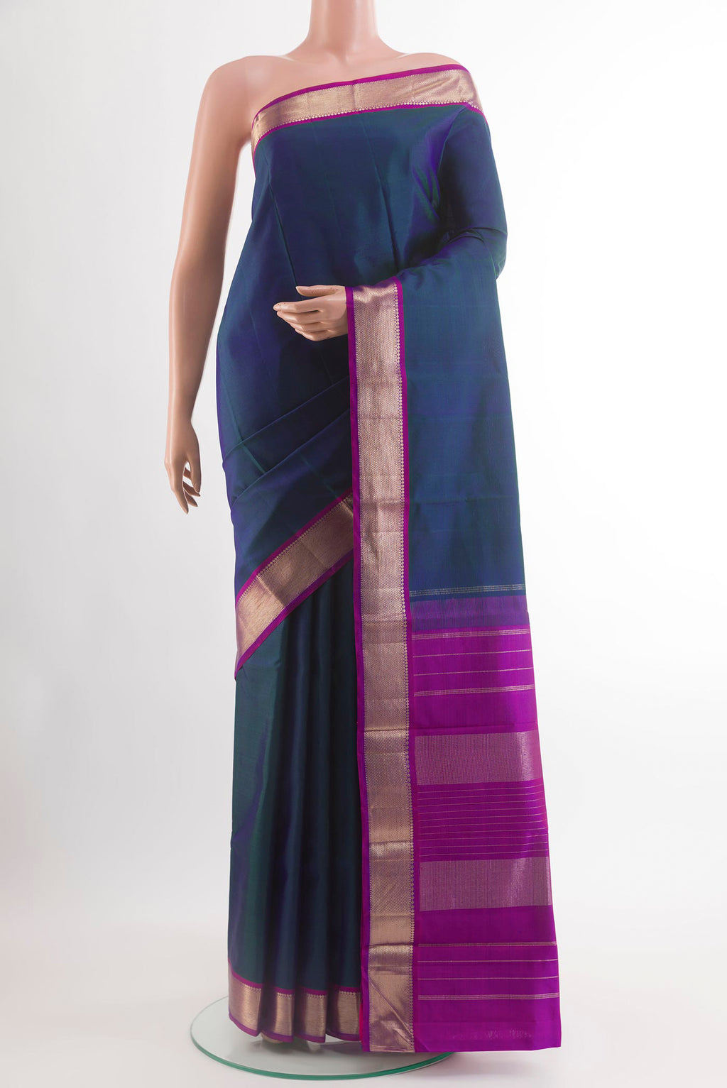 Peacock Blue Kanchipuram Silk Saree with Plain Body and Zari Border.  displayed on a mannequin