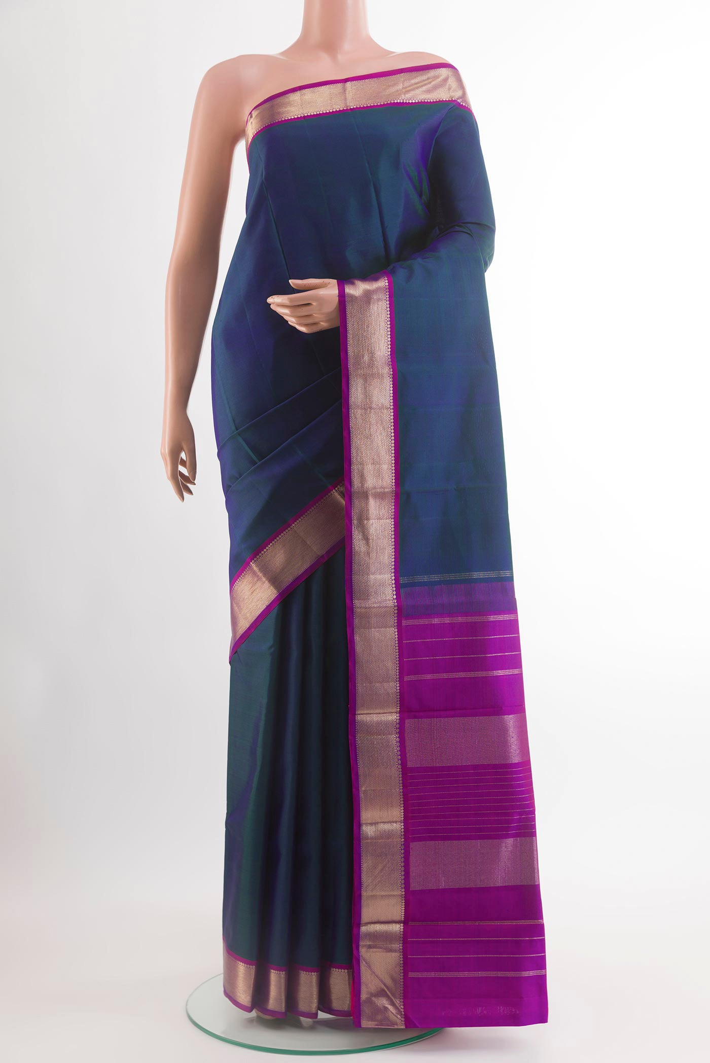 Peacock Blue Kanchipuram Silk Saree with Plain Body and Zari Border.  displayed on a mannequin