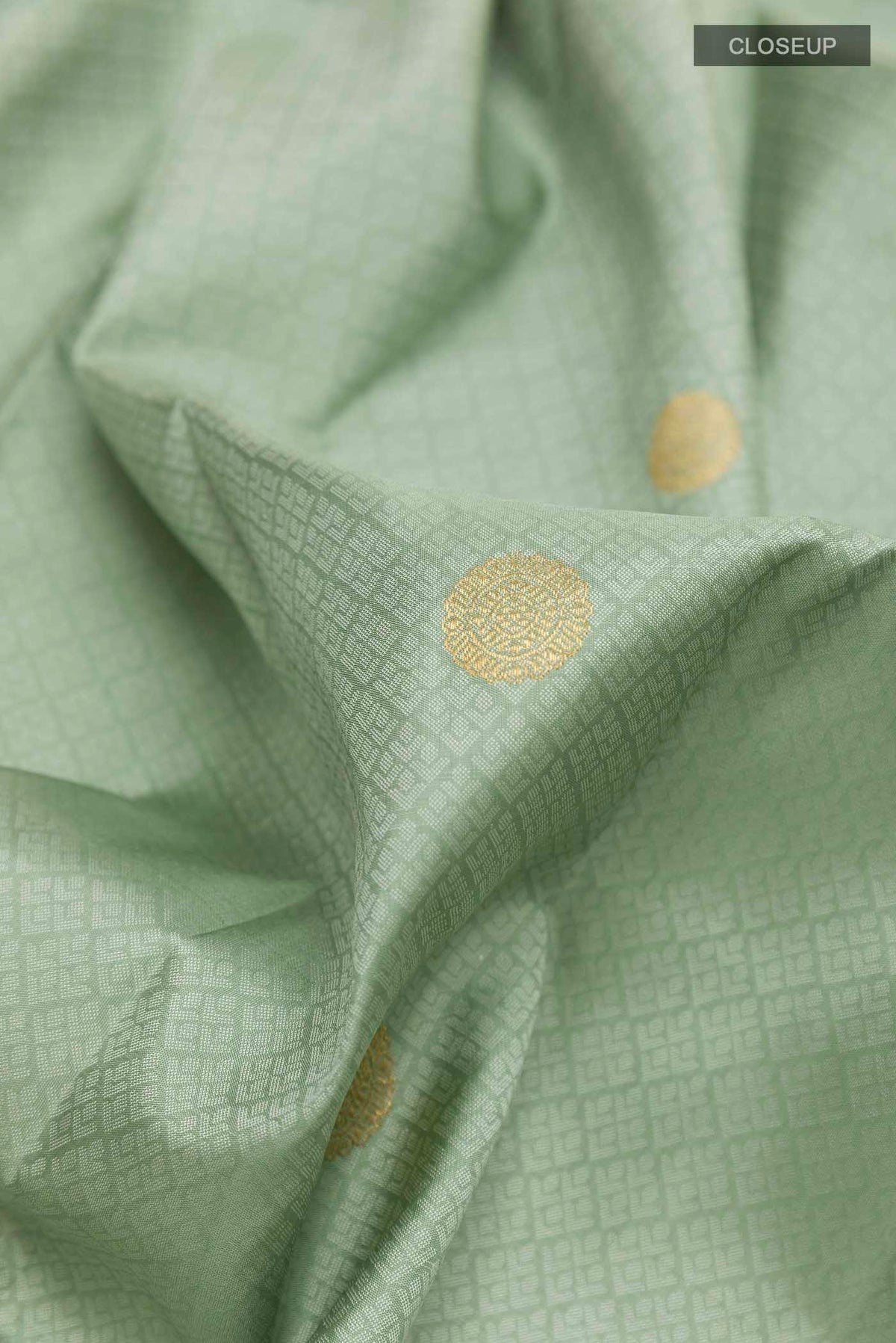 Close up of Sea Green Kanchipuram Silk Saree with Jacquard With Zari Butta on the body and Zari Border displaying folds