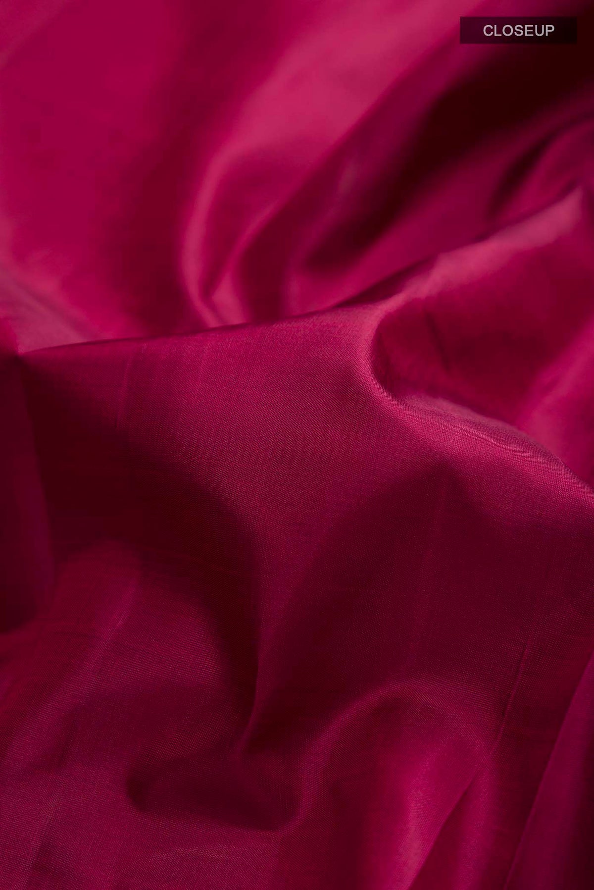 Close up of Maroon Kanchipuram Silk Saree with Plain Body and Zari Border displaying folds