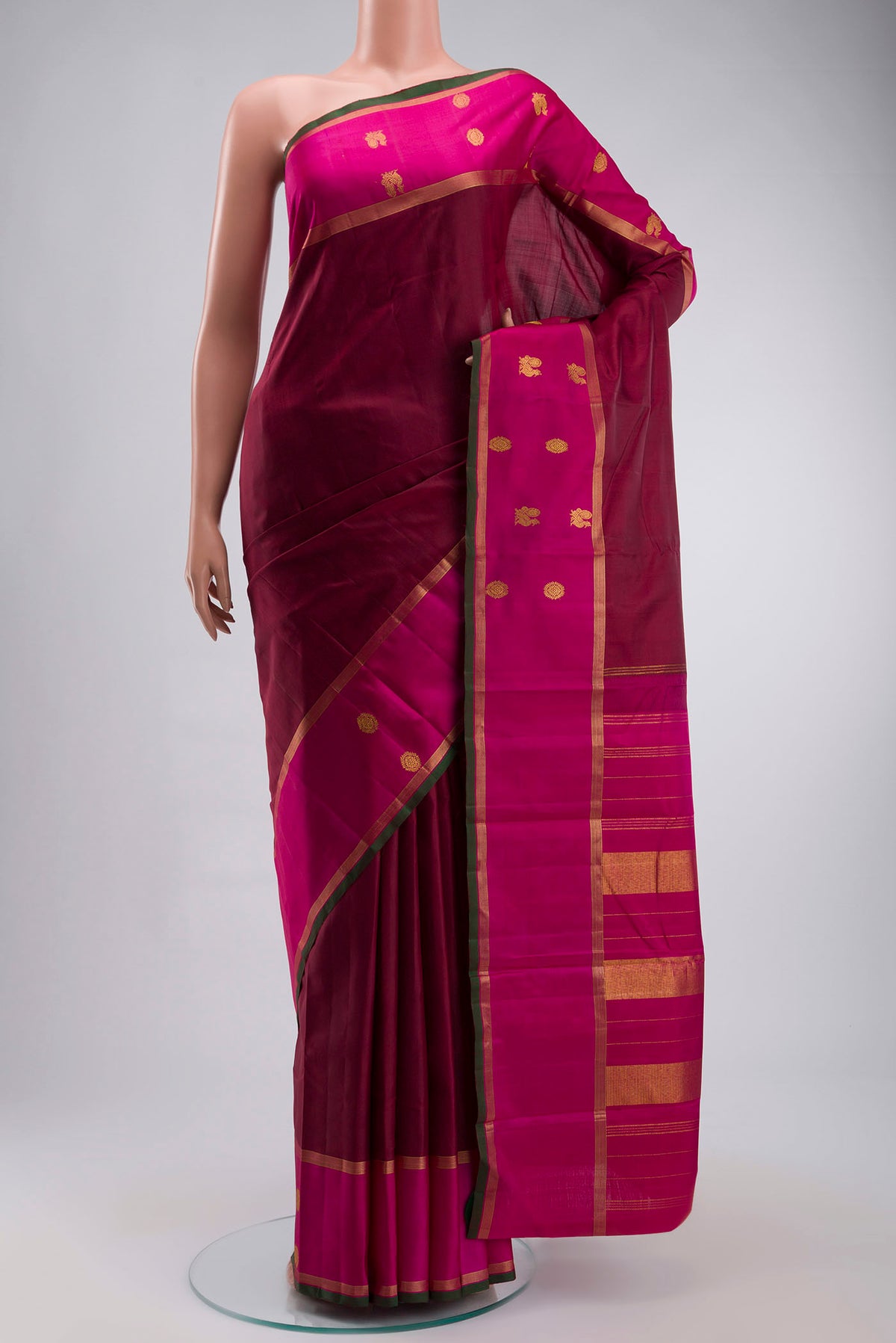 Maroon Kanchipuram Silk Saree with Plain Body and Zari Border displayed on a mannequin