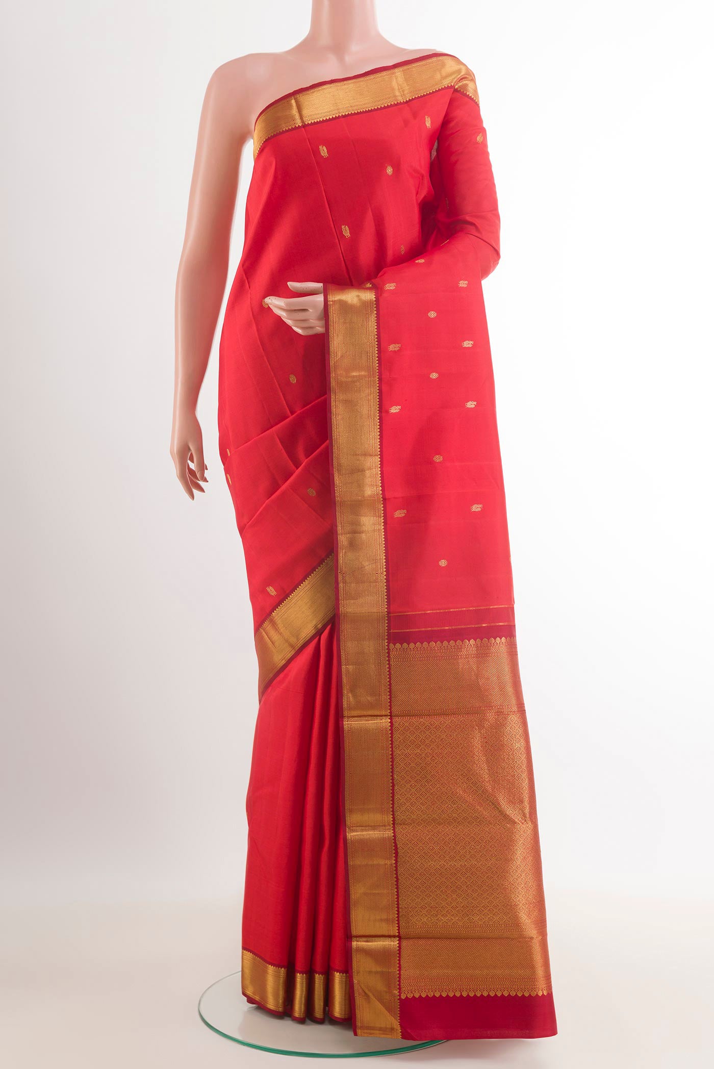 Brick Orange Pochampally Silk Saree with Pure Ikat on the body and Zari Border.  displayed on a mannequin