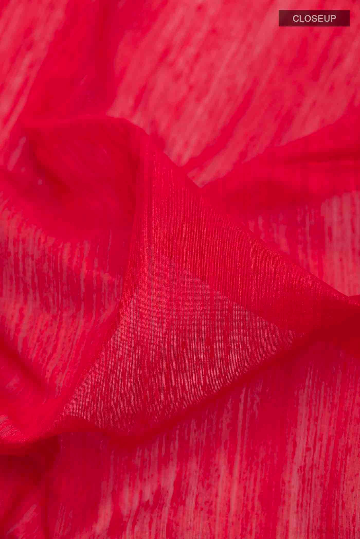Close up of Red Tussar Saree with Plain Body and Zari Border displaying folds