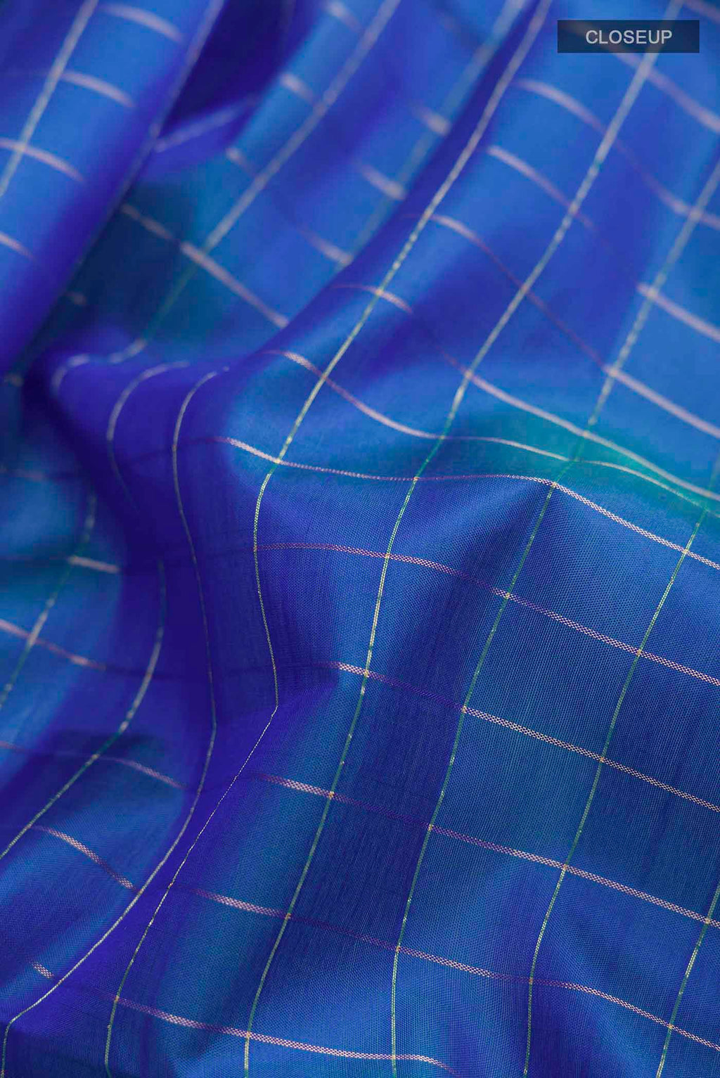 Close up of Blue Soft Silk Saree with Zari Butta on the body and Zari Border displaying folds
